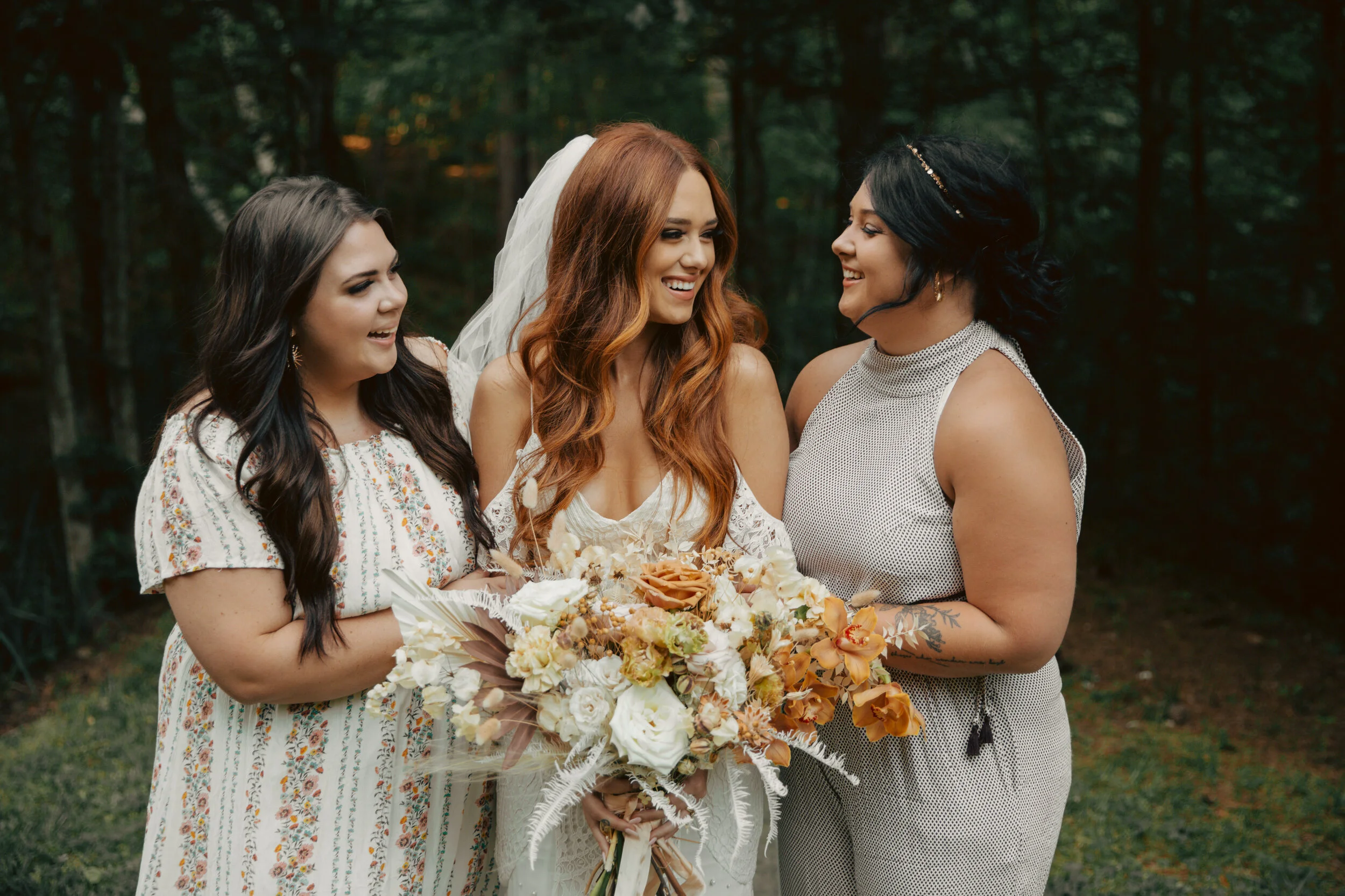 Bohemian, modern floral installation with gold and blush roses, pampas grass, dried ferns, and dried palms, growing on a private dock with a Turkish rug. Nashville wedding florist.
