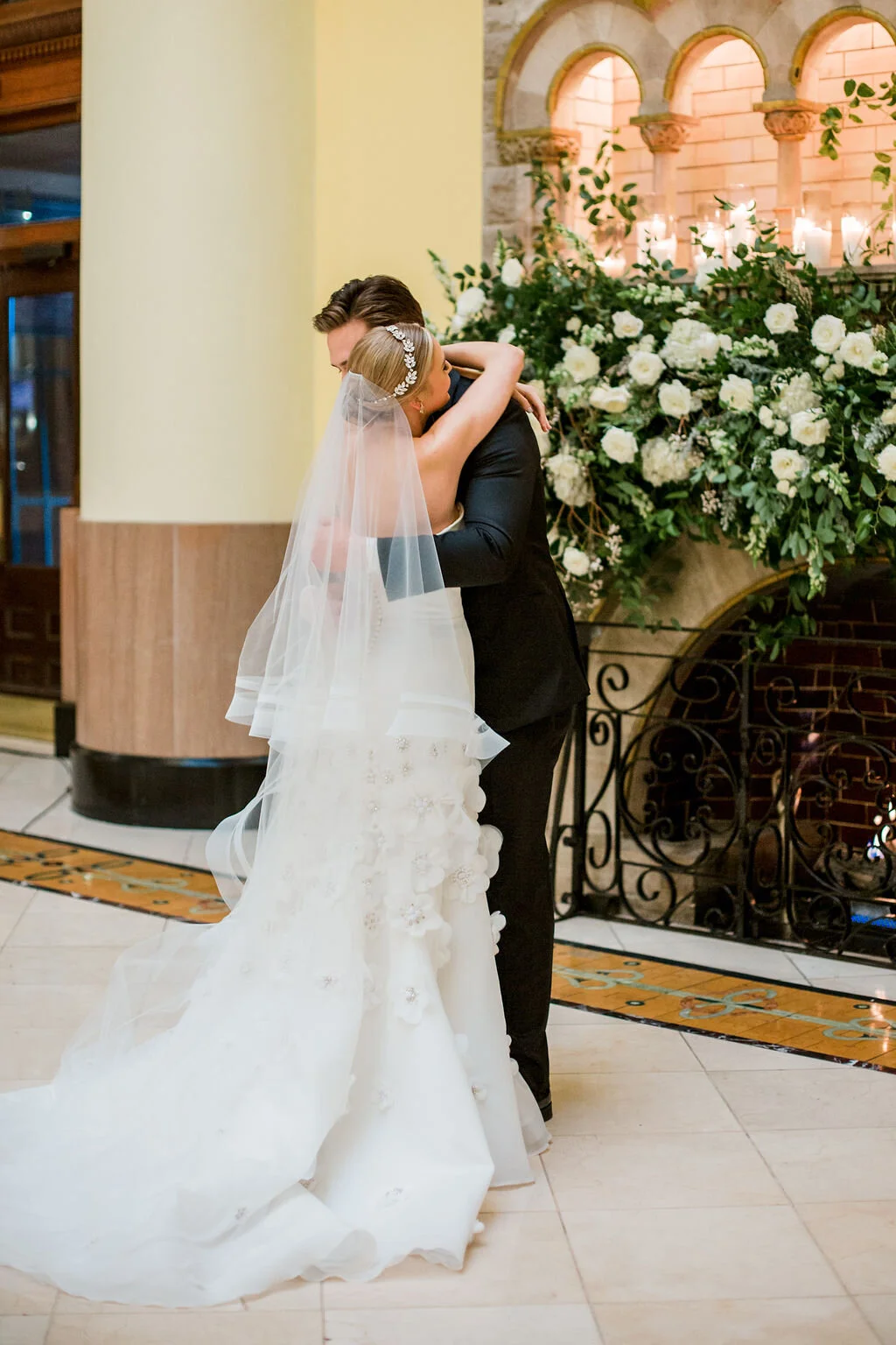 Lush fireplace mantle floral installation with all white garden roses and ranunculus with natural, untamed greenery and eucalyptus. Nashville floral designer, Rosemary & Finch, for a wedding at Union Station.