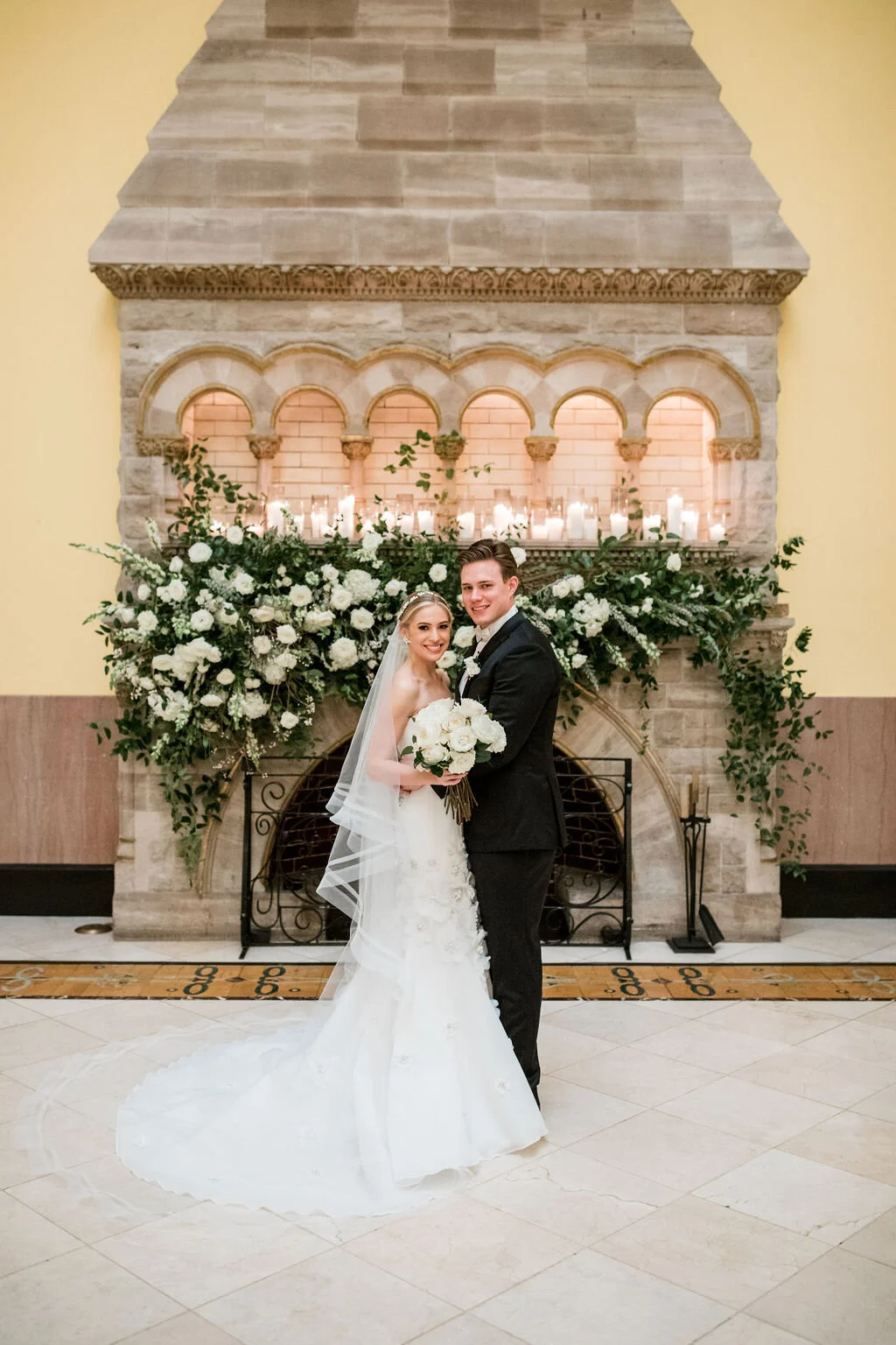 Lush fireplace mantle floral installation with all white garden roses and ranunculus with natural, untamed greenery and eucalyptus. Nashville floral designer, Rosemary & Finch, for a wedding at Union Station.