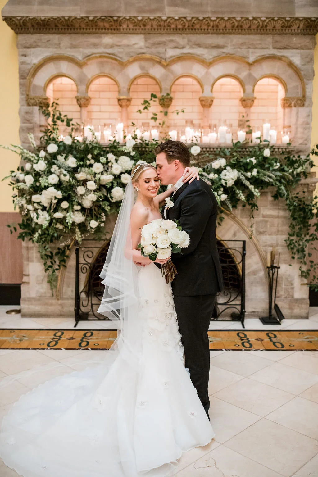 Lush fireplace mantle floral installation with all white garden roses and ranunculus with natural, untamed greenery and eucalyptus. Nashville floral designer, Rosemary & Finch, for a wedding at Union Station.