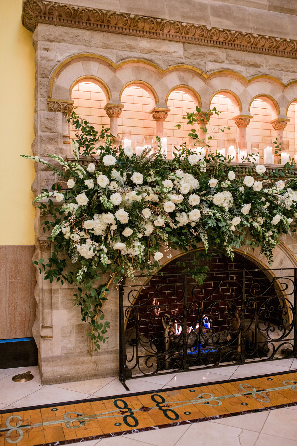 Lush fireplace mantle floral installation with all white garden roses, hydrangeas, and ranunculus with natural, untamed greenery and eucalyptus. Nashville floral designer, Rosemary & Finch, for a wedding at Union Station.