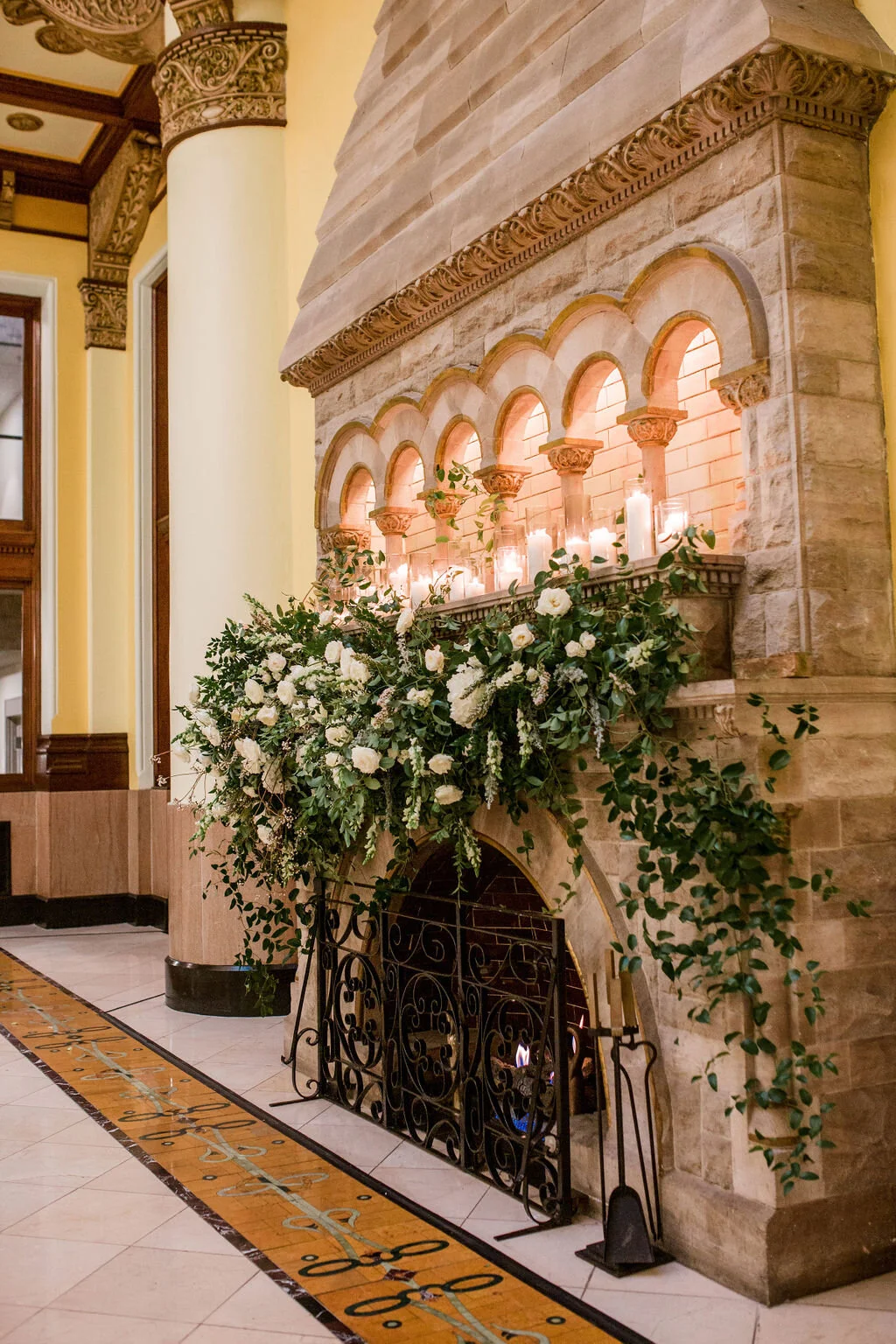 Lush fireplace mantle floral installation with all white garden roses, hydrangeas, and ranunculus with natural, untamed greenery and eucalyptus. Nashville floral designer, Rosemary & Finch, for a wedding at Union Station.