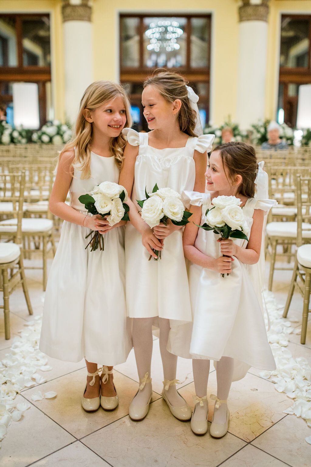 Flower girls for an all white and greenery winter wedding flowers. Nashville wedding florist, Rosemary & Finch, at Union Station Hotel.