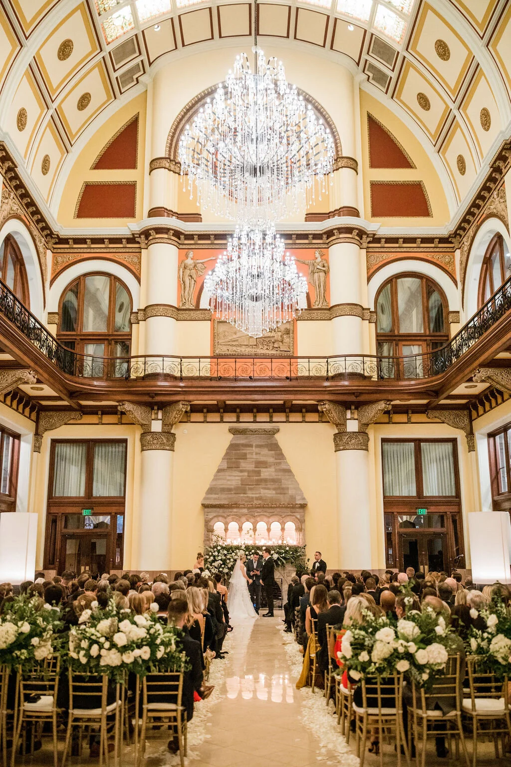 Lush fireplace mantle floral installation with all white garden roses, hydrangeas, and ranunculus with natural, untamed greenery and eucalyptus. Nashville floral designer, Rosemary & Finch, for a wedding at Union Station.