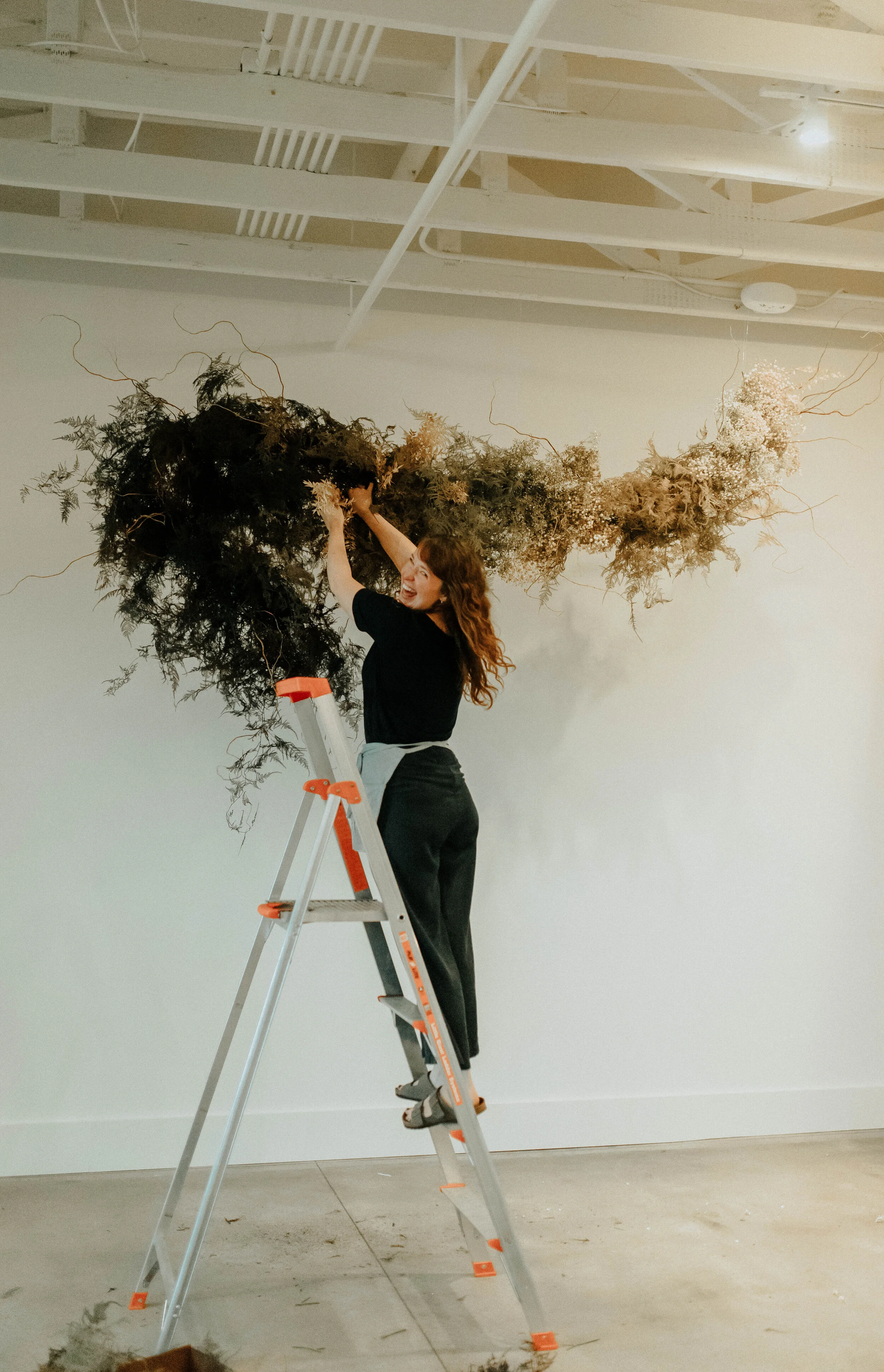 Skin tone inspired wearable floral design inspiration shoot. Earth tone hanging flower installation at the Saint Elle, Nashville.