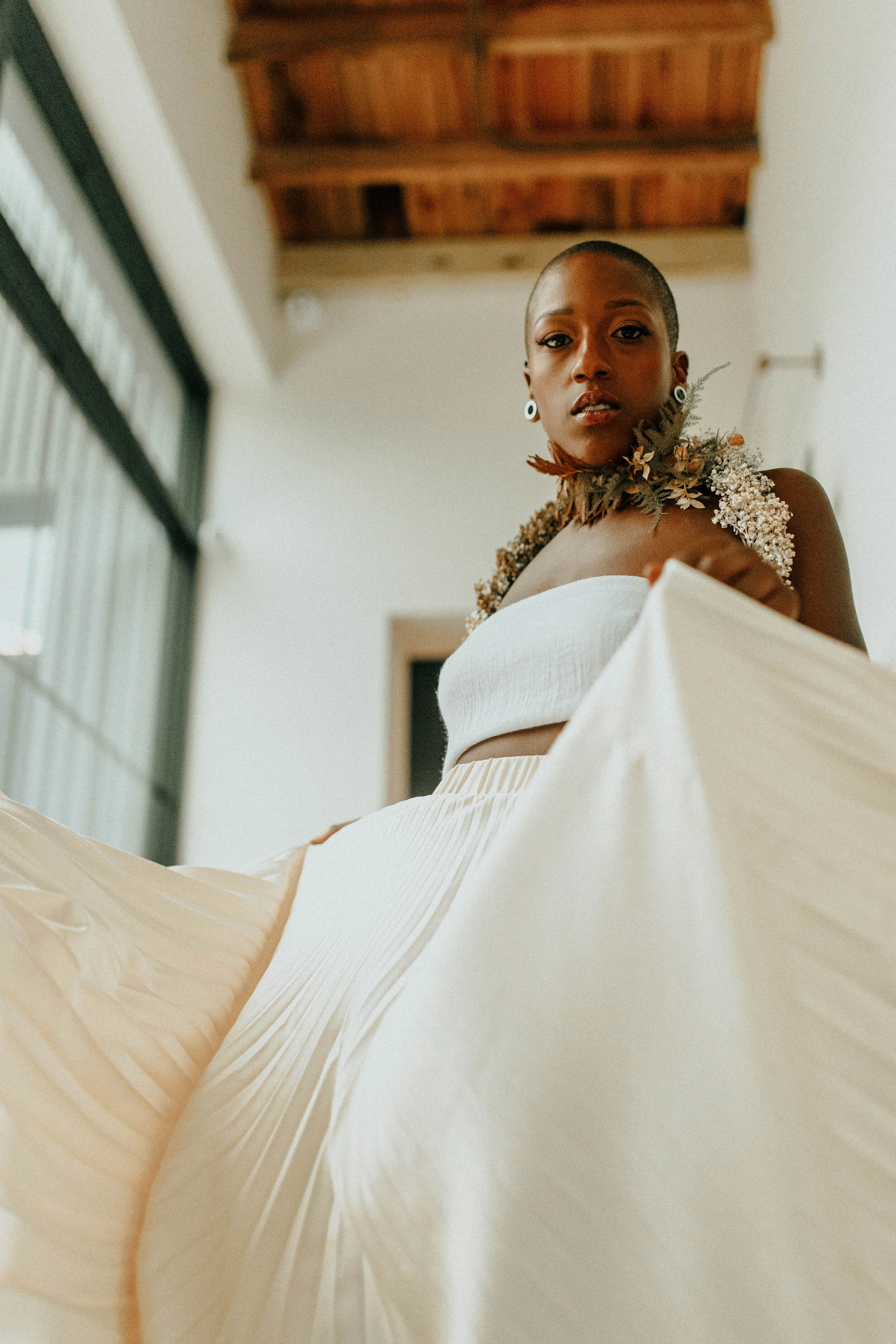 Earthy neutral floral design with flower necklace and wearable florals. Nashville wedding florist at the Saint Elle.