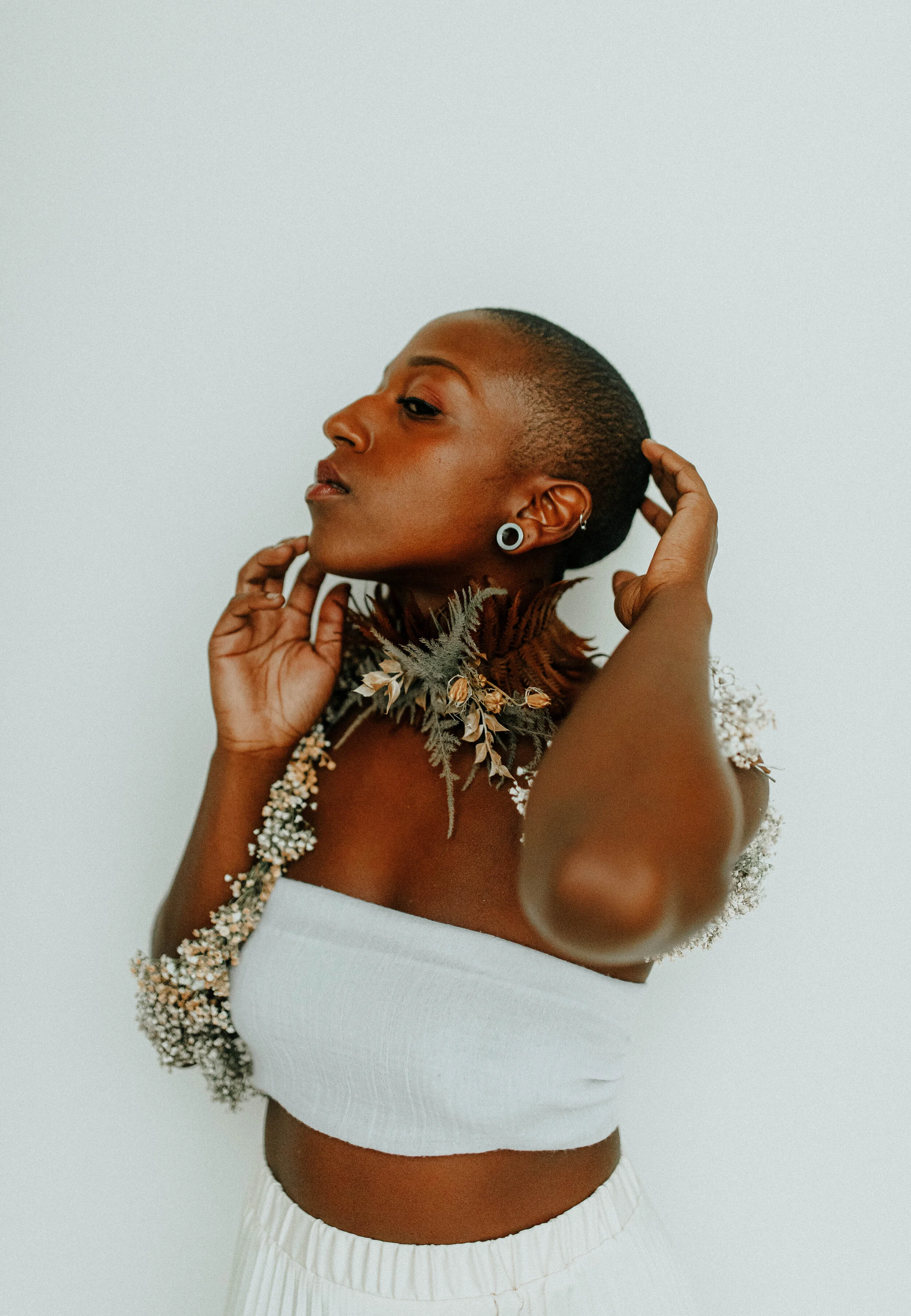 Earthy neutral floral design with flower necklace and wearable florals. Nashville wedding florist at the Saint Elle.