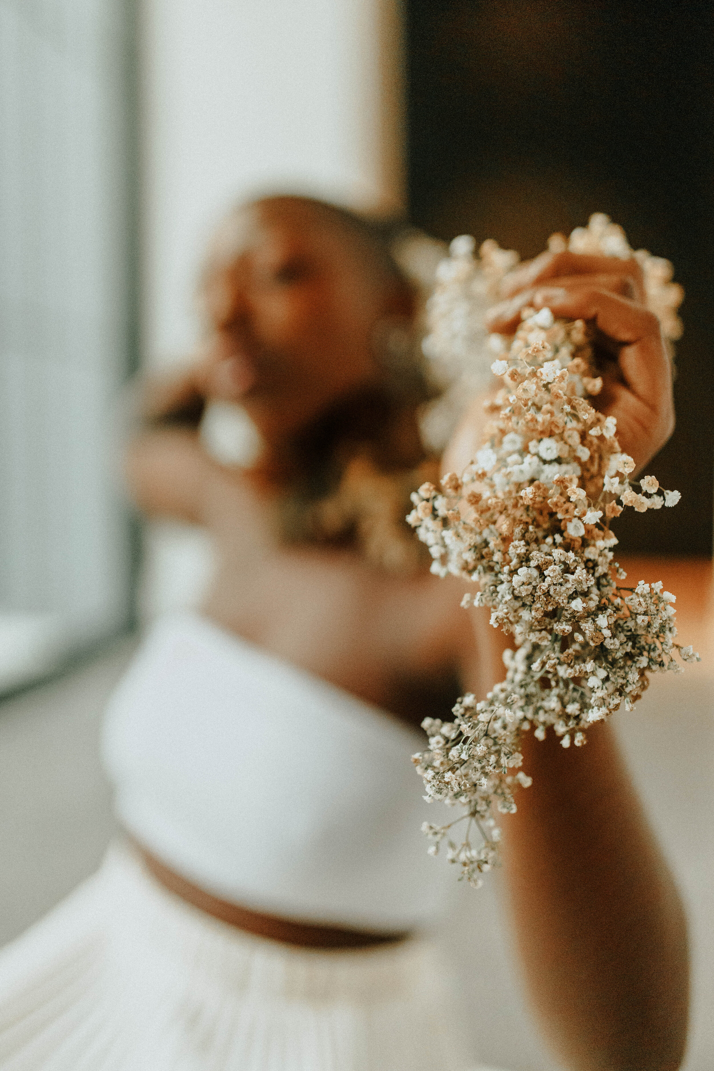 Earthy neutral floral design with flower necklace and wearable florals. Nashville wedding florist at the Saint Elle.