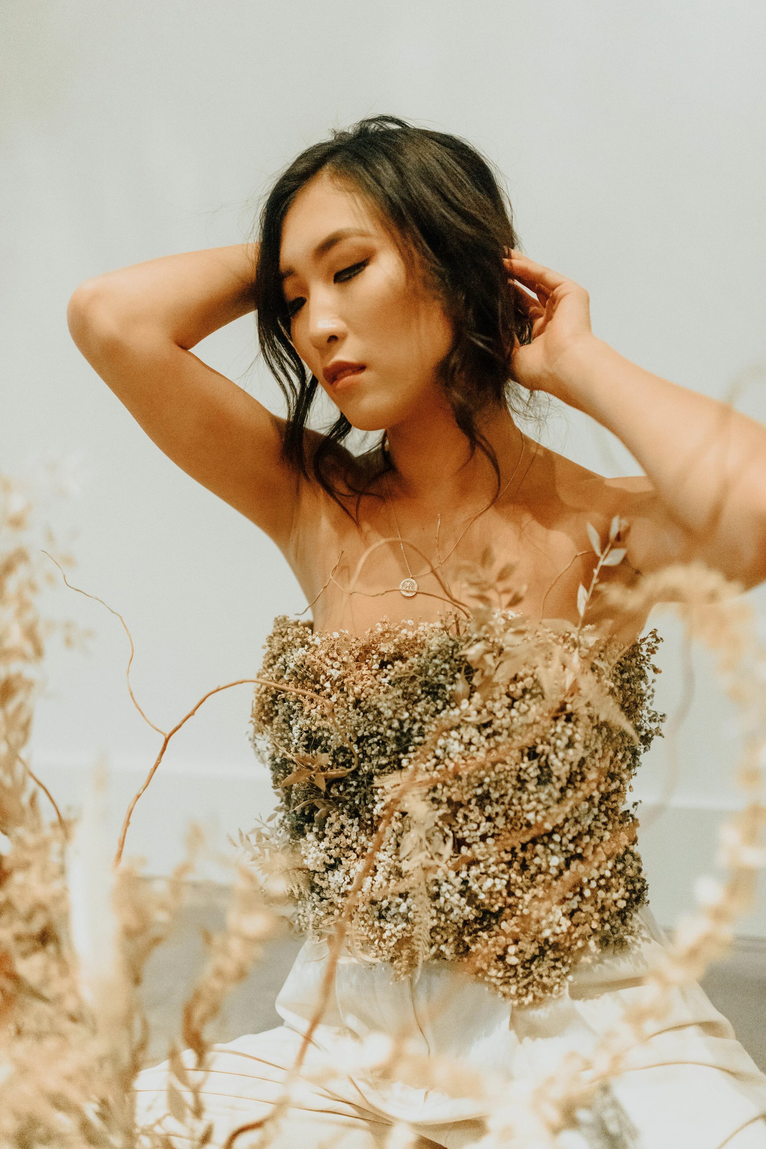 Earth tone floral design with shirt made of flowers - dyed baby’s breath. Nashville wedding florist at the Saint Elle.
