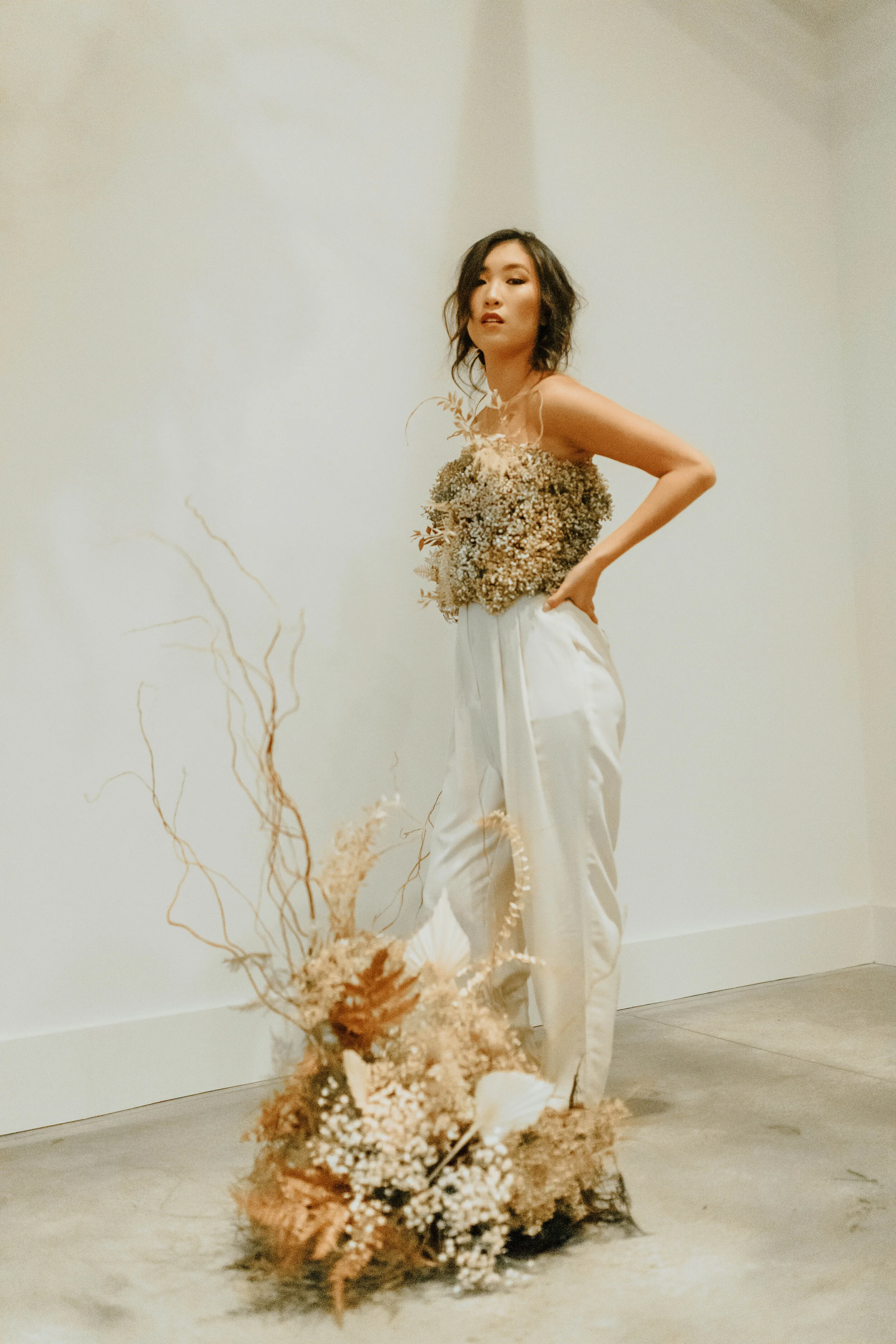 Earth tone floral design with shirt made of flowers - dyed baby’s breath. Nashville wedding florist at the Saint Elle.