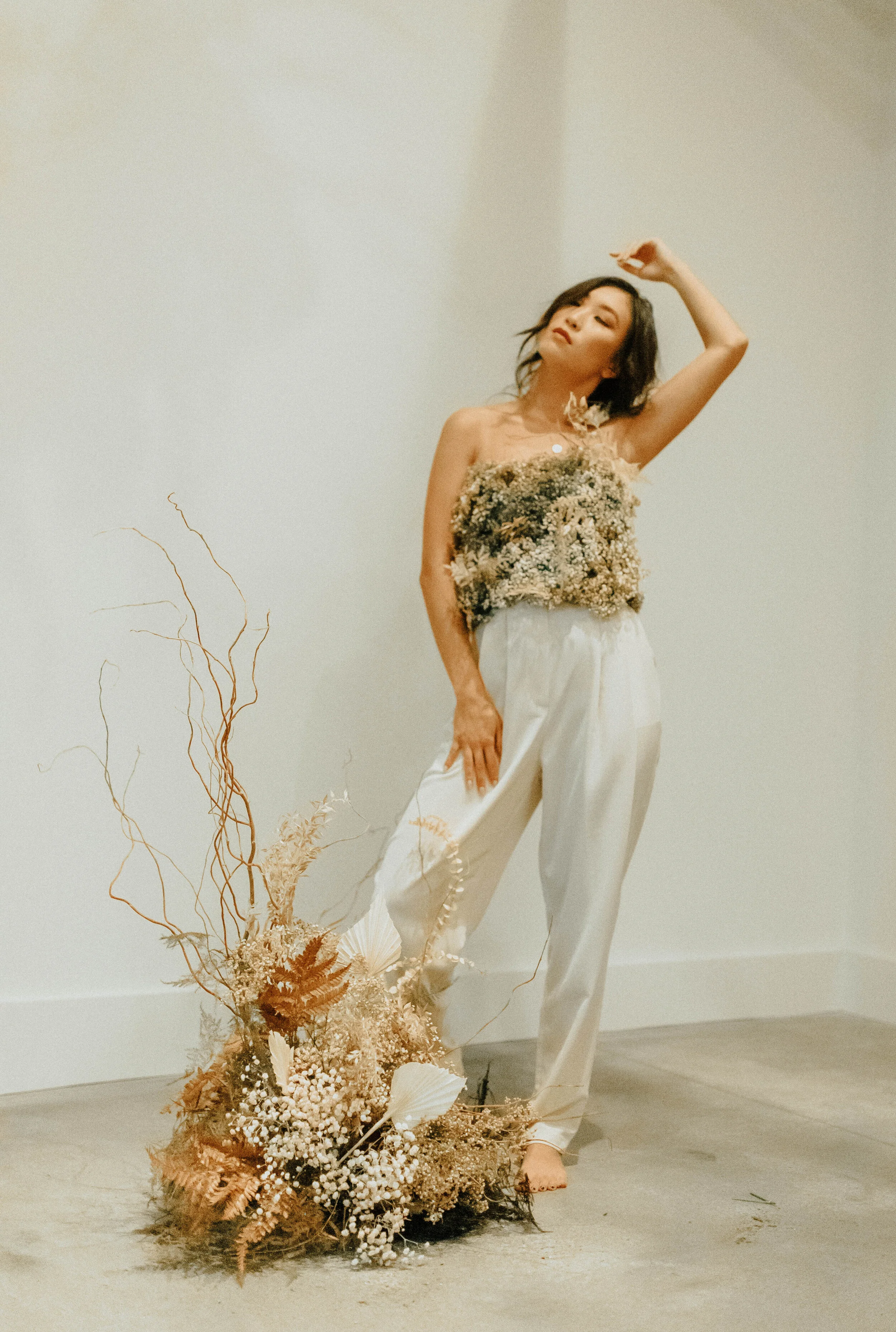 Earth tone floral design with shirt made of flowers - dyed baby’s breath. Nashville wedding florist at the Saint Elle.