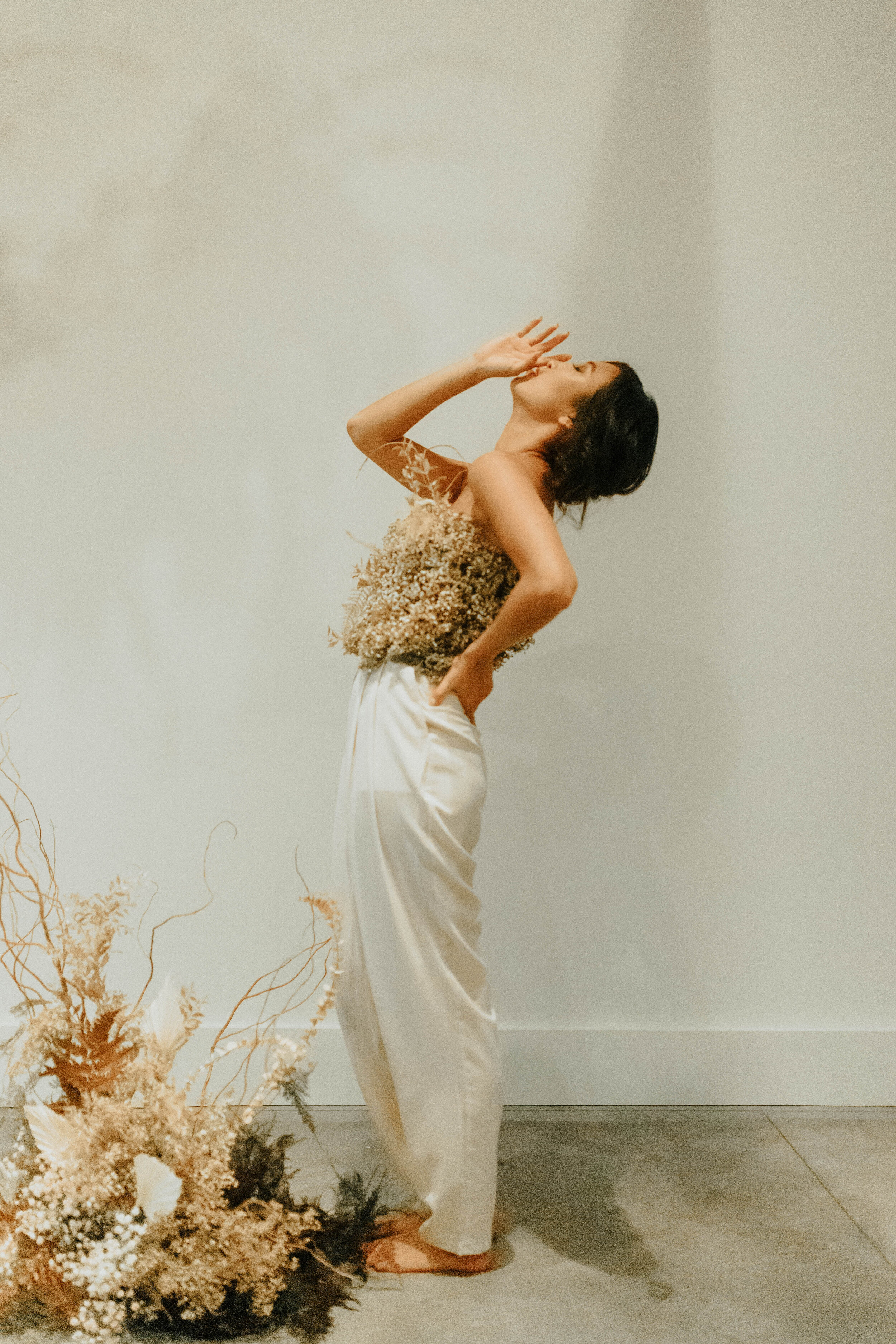 Earth tone floral design with shirt made of flowers - dyed baby’s breath. Nashville wedding florist at the Saint Elle.