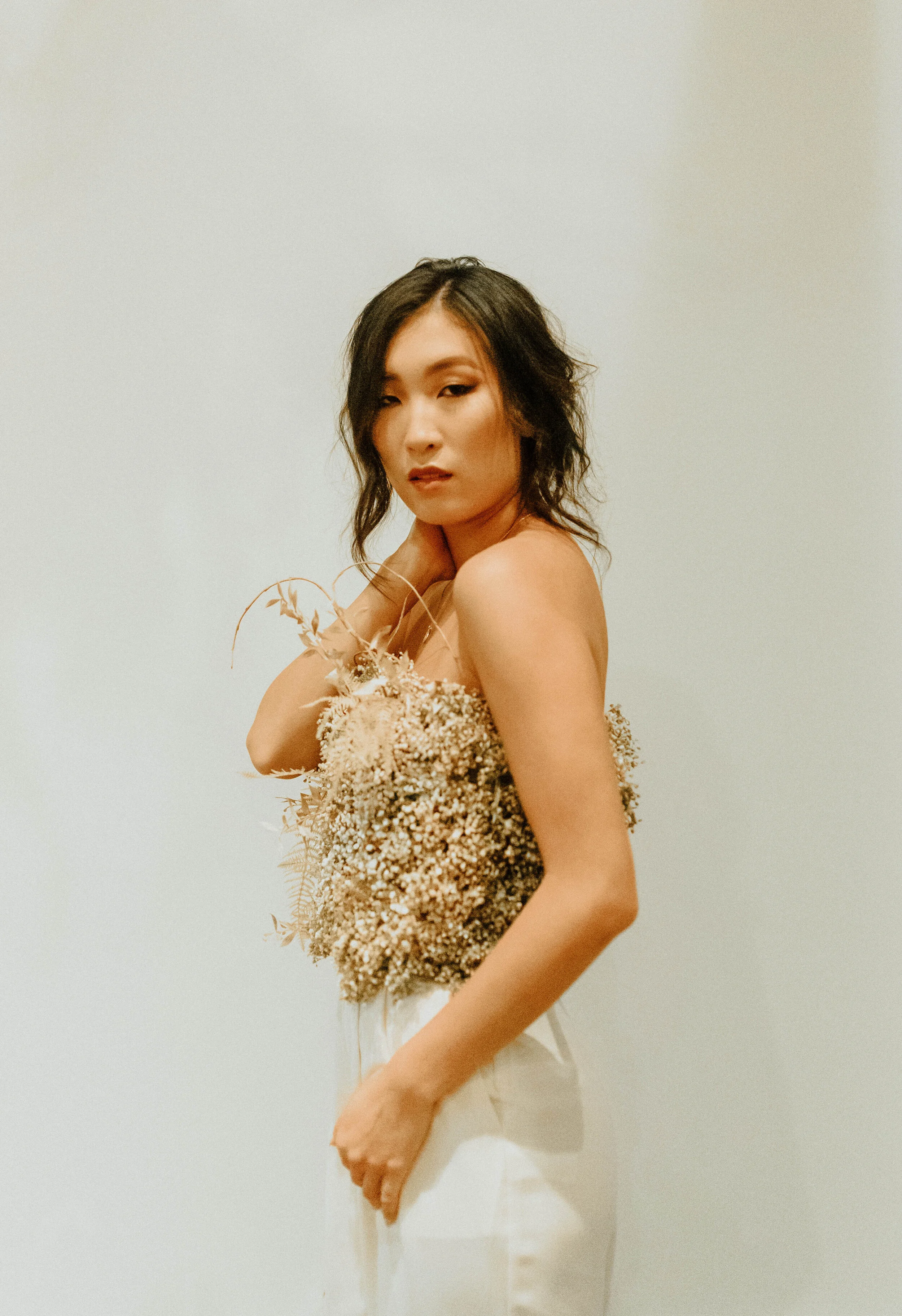 Earth tone floral design with shirt made of flowers - dyed baby’s breath. Nashville wedding florist at the Saint Elle.