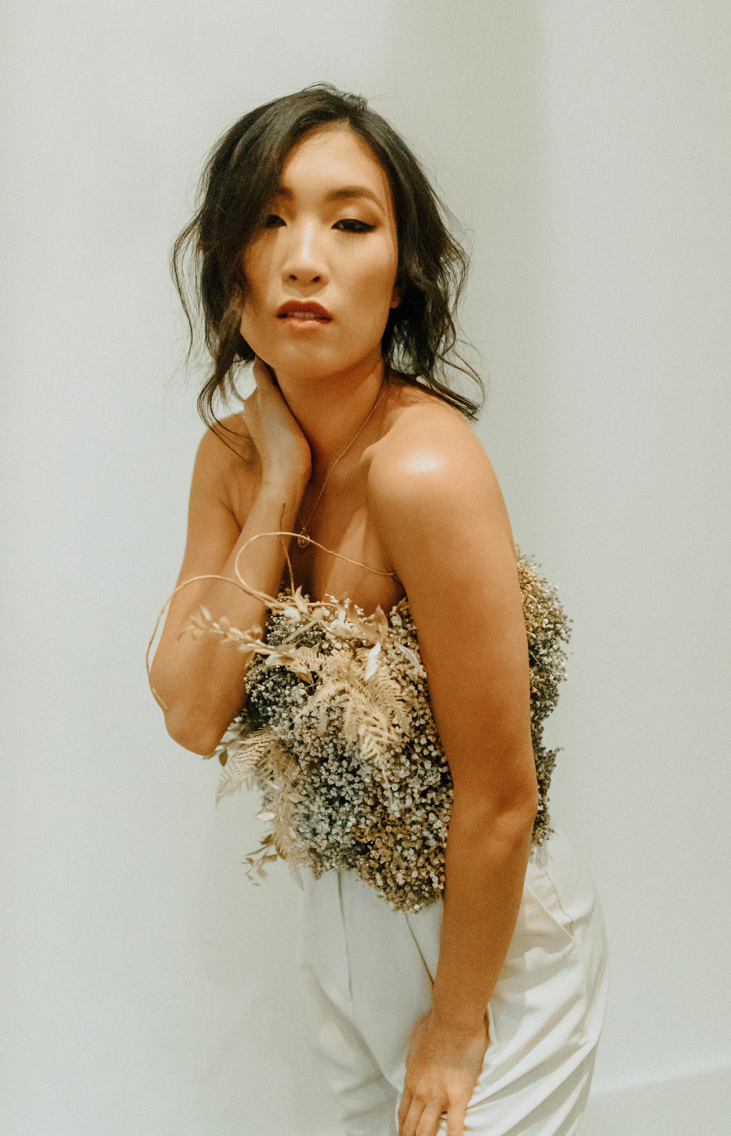 Earth tone floral design with shirt made of flowers - dyed baby’s breath. Nashville wedding florist at the Saint Elle.