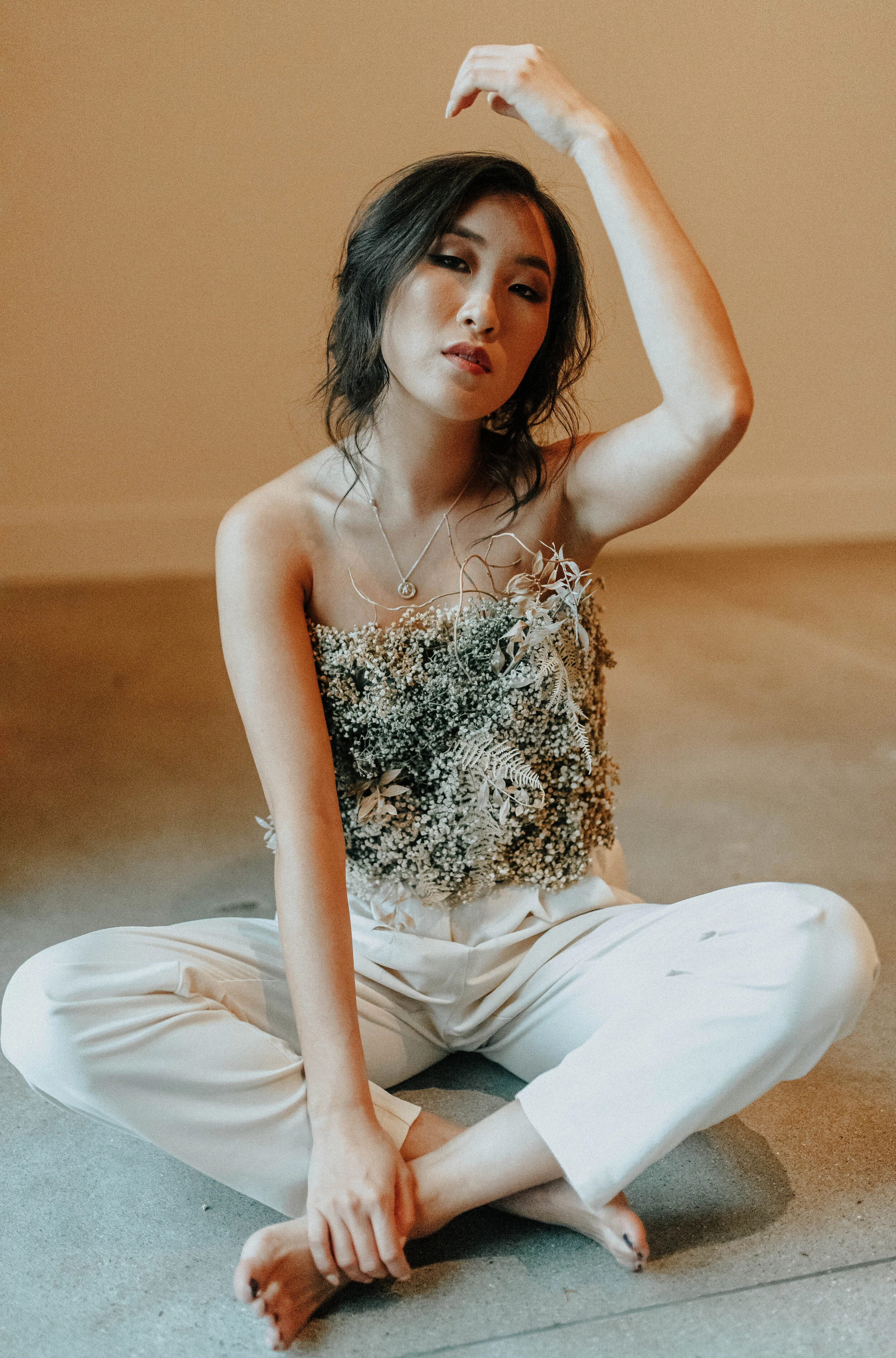 Earth tone floral design with shirt made of flowers - dyed baby’s breath. Nashville wedding florist at the Saint Elle.