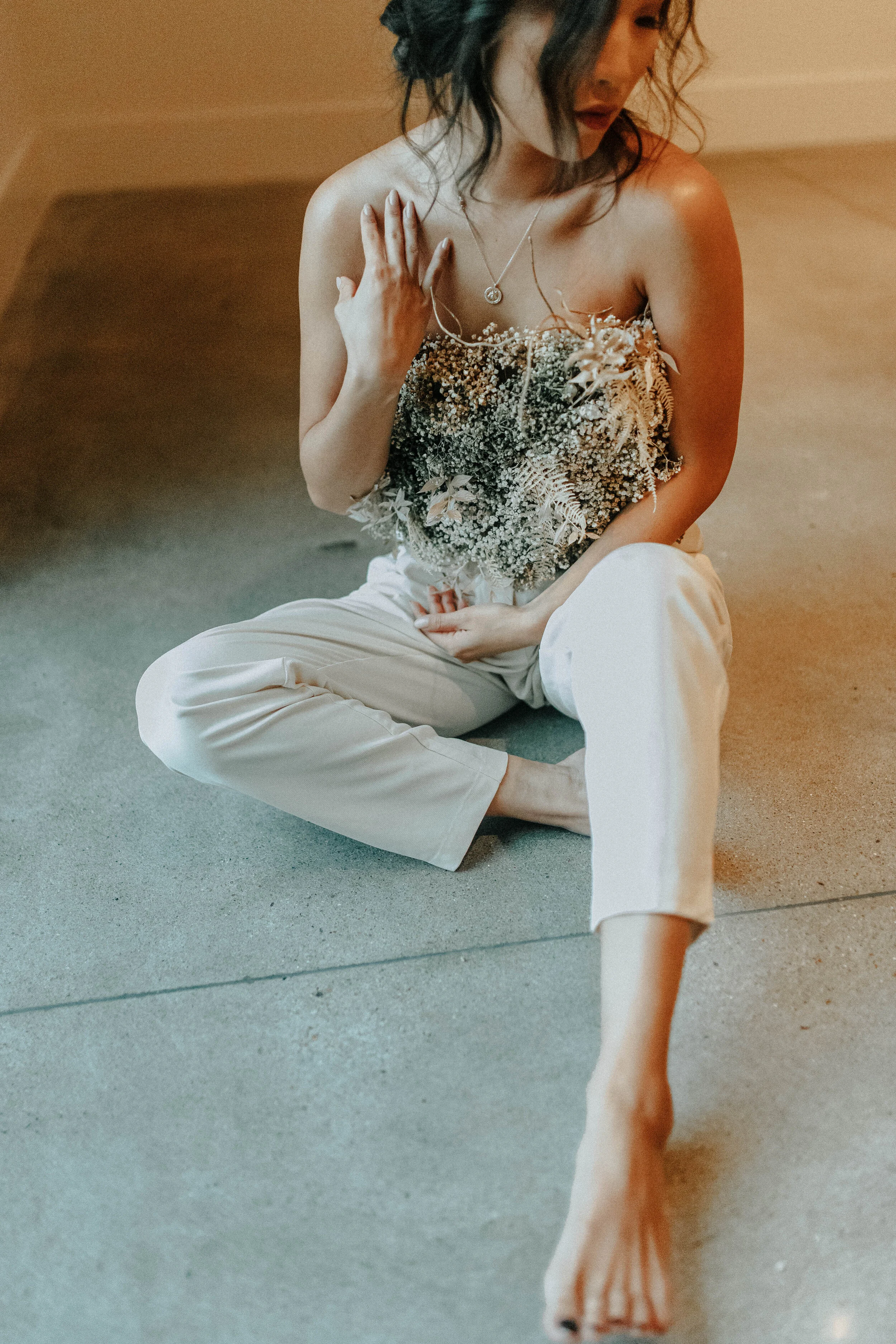 Earth tone floral design with shirt made of flowers - dyed baby’s breath. Nashville wedding florist at the Saint Elle.