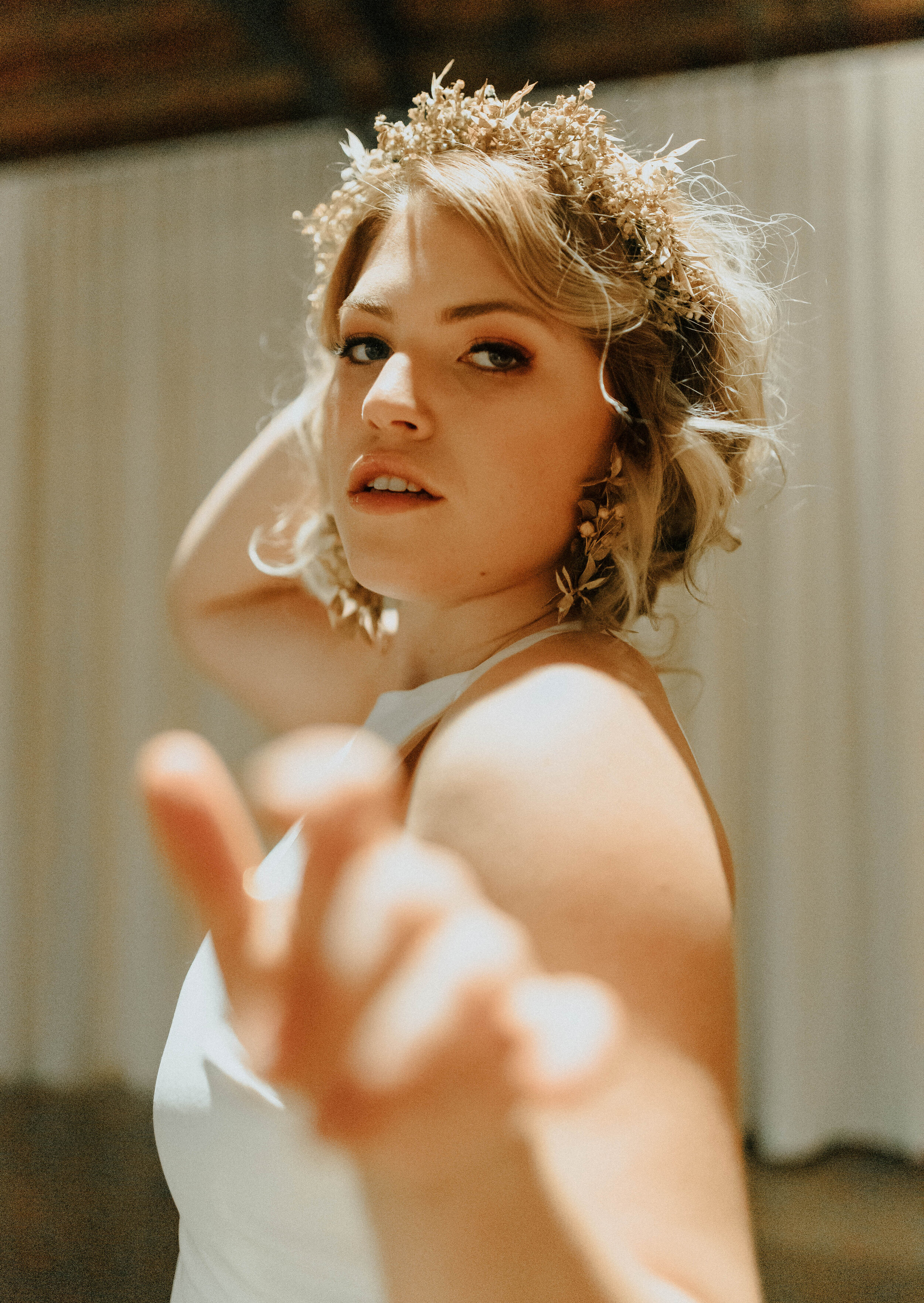 Earthy neutral floral design with flower crown, earrings, and wearable florals. Nashville wedding florist at the Saint Elle.