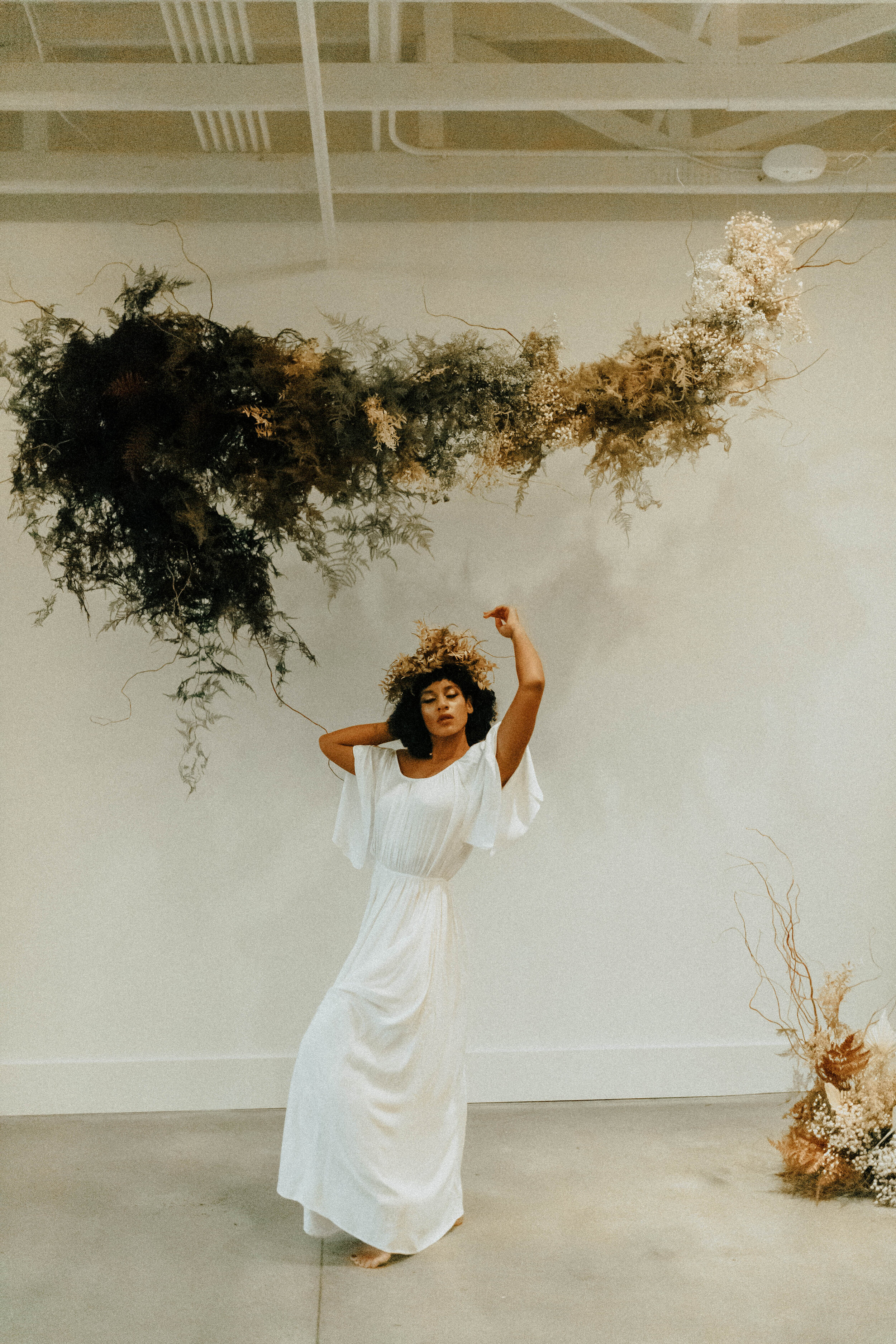 Skin tone inspired wearable floral design inspiration shoot. Earth tone hanging flower crown and floral installation at the Saint Elle, Nashville.
