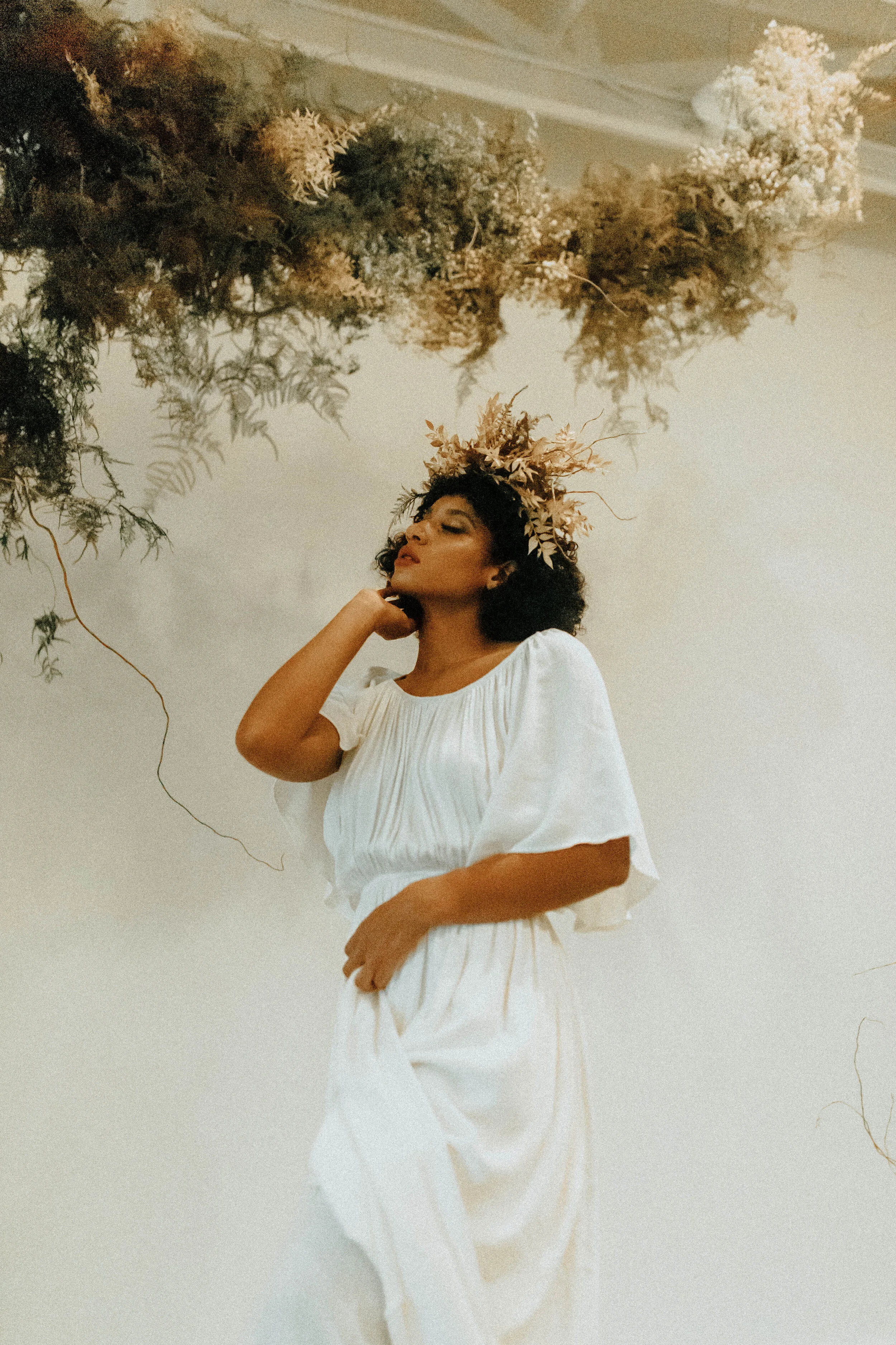 Skin tone inspired wearable floral design inspiration shoot. Earth tone hanging flower crown and floral installation at the Saint Elle, Nashville.