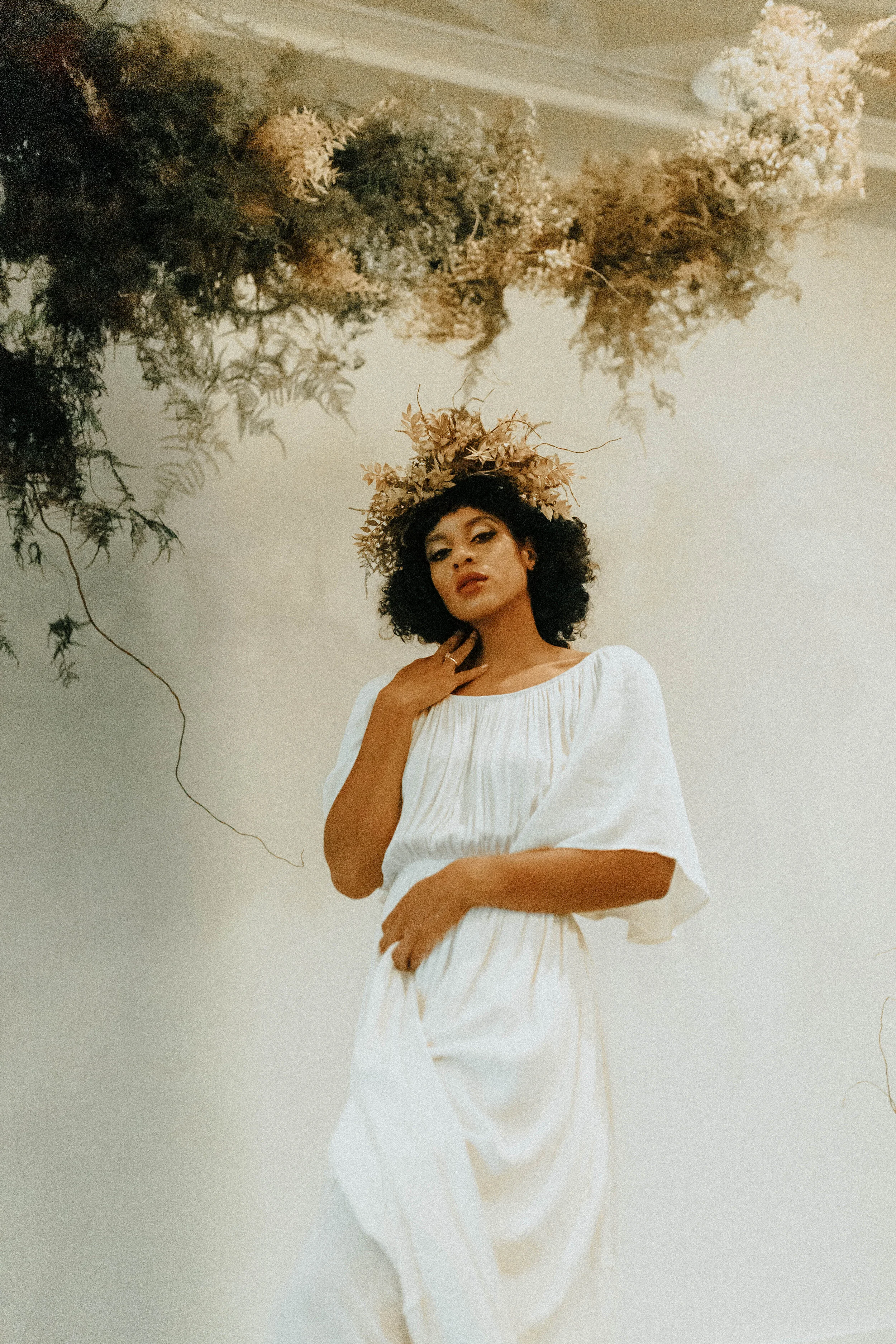 Skin tone inspired wearable floral design inspiration shoot. Earth tone hanging flower crown and floral installation at the Saint Elle, Nashville.