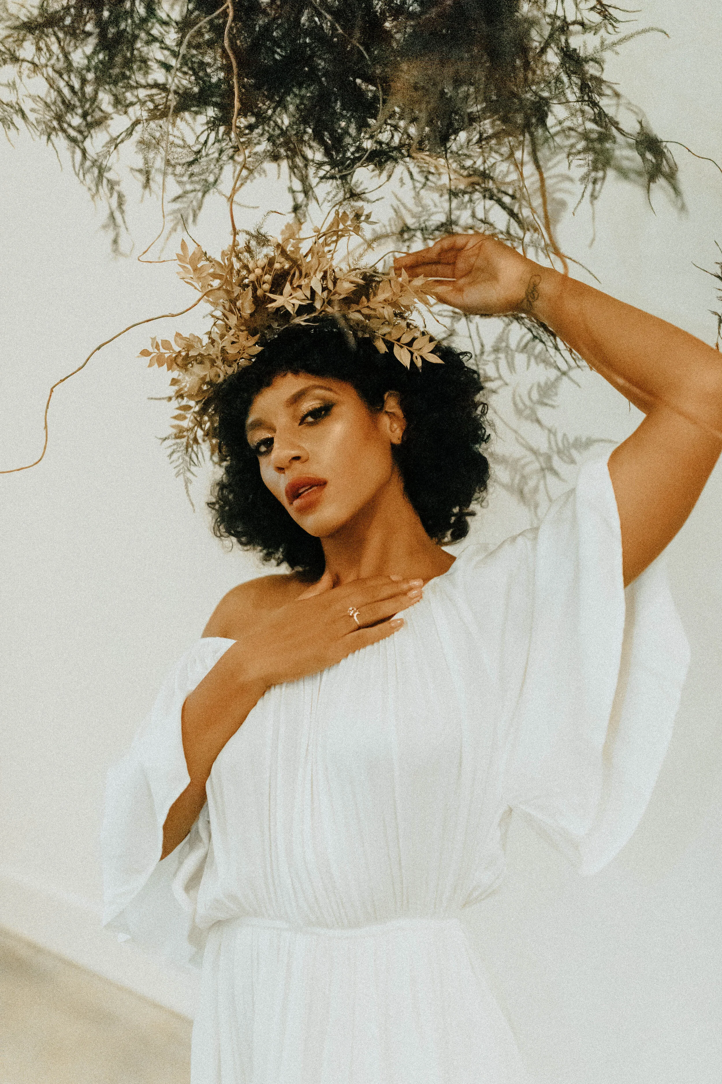 Skin tone inspired wearable floral design inspiration shoot. Earth tone hanging flower crown and floral installation at the Saint Elle, Nashville.