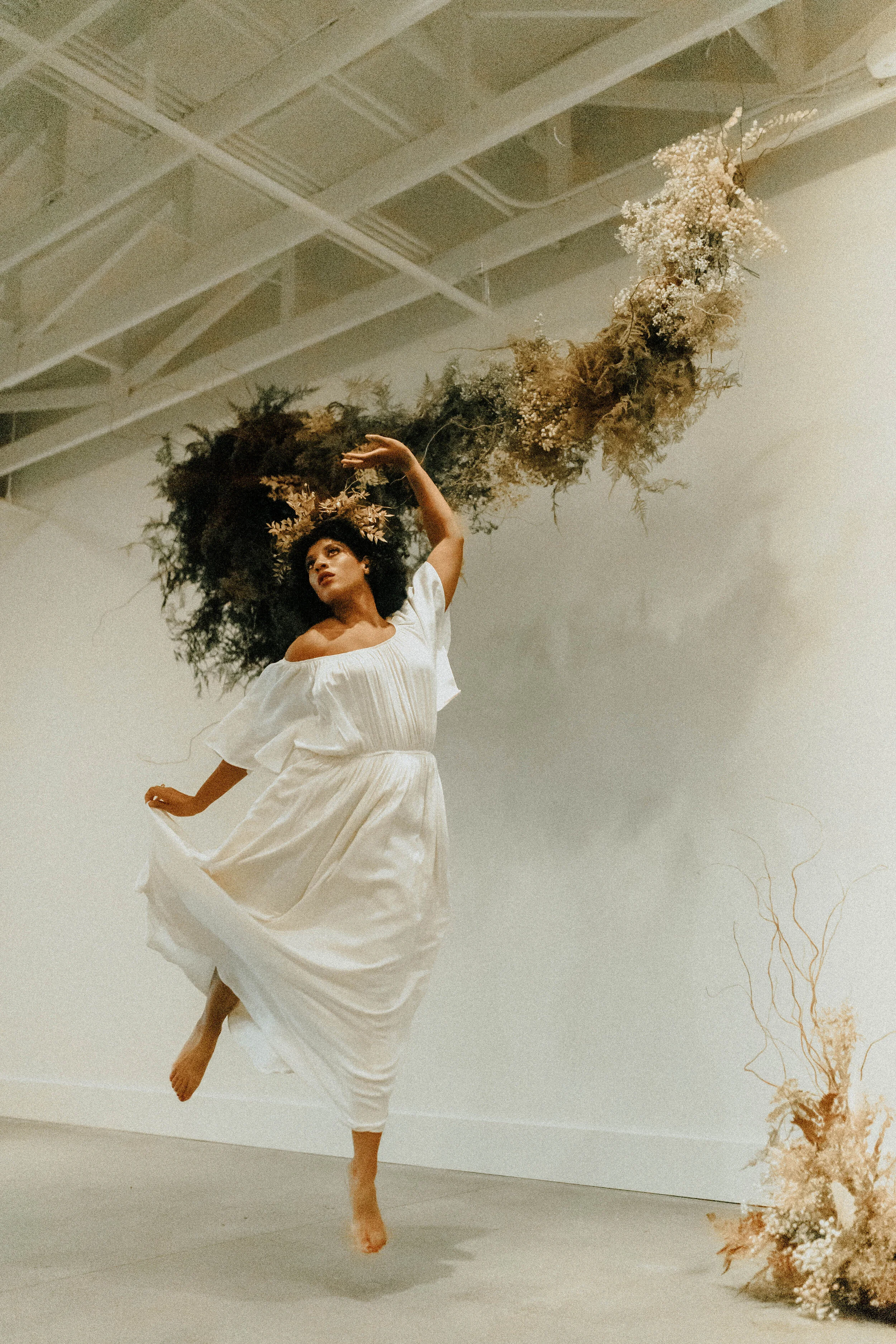 Skin tone inspired wearable floral design inspiration shoot. Earth tone hanging flower crown and floral installation at the Saint Elle, Nashville.