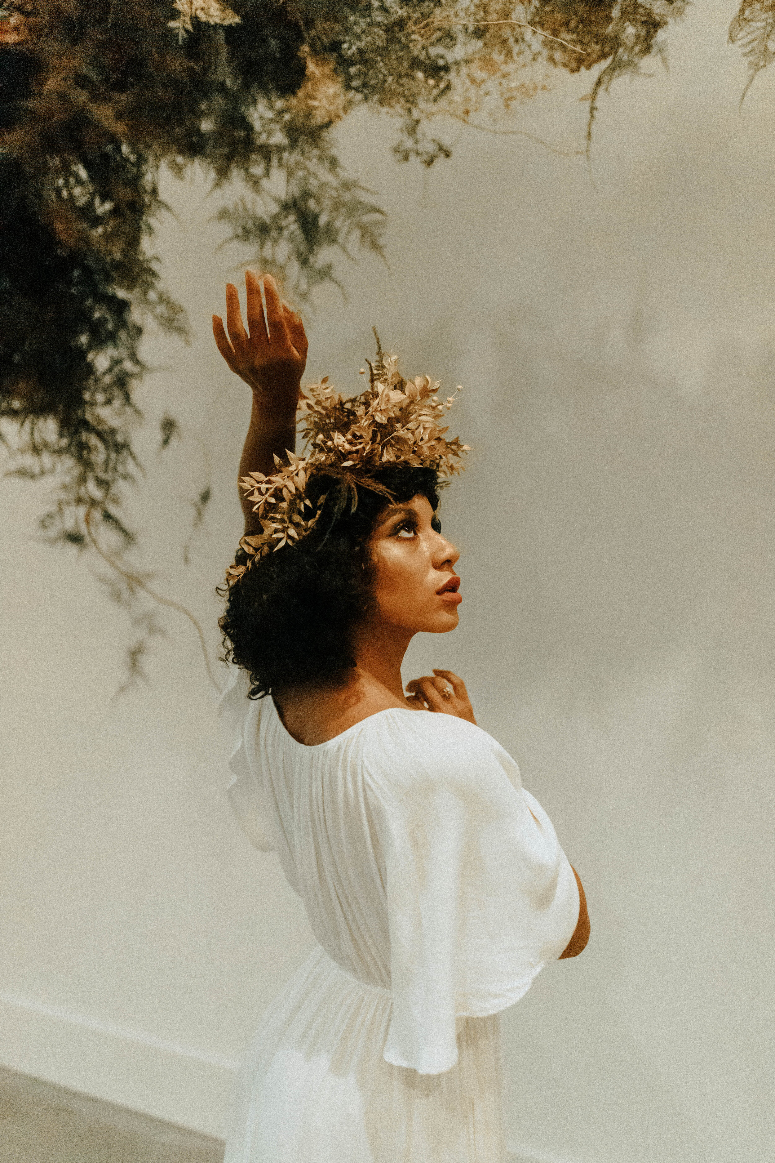 Skin tone inspired wearable floral design inspiration shoot. Earth tone hanging flower crown and floral installation at the Saint Elle, Nashville.