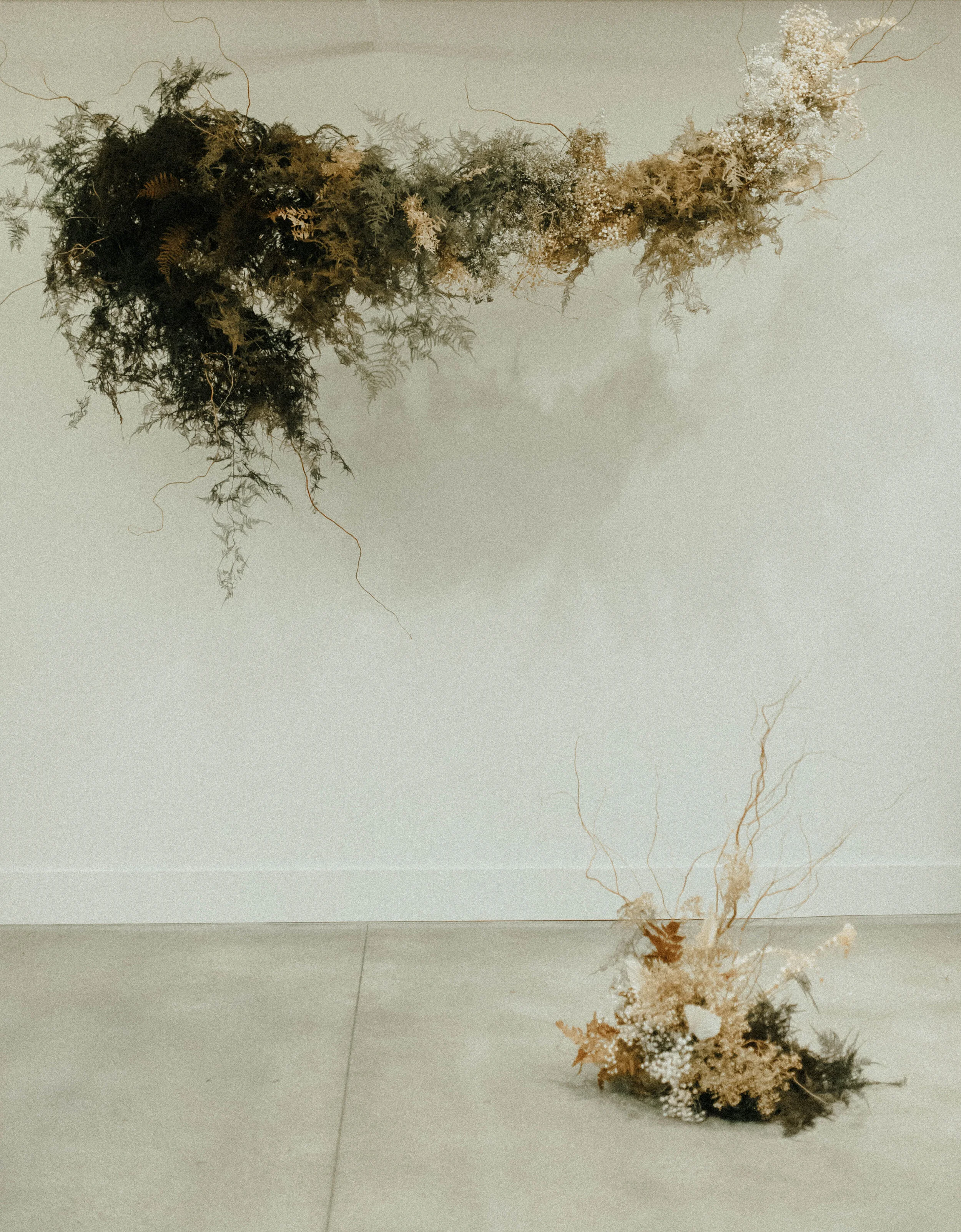 Skin tone inspired wearable floral design inspiration shoot. Earth tone hanging flower installation at the Saint Elle, Nashville.