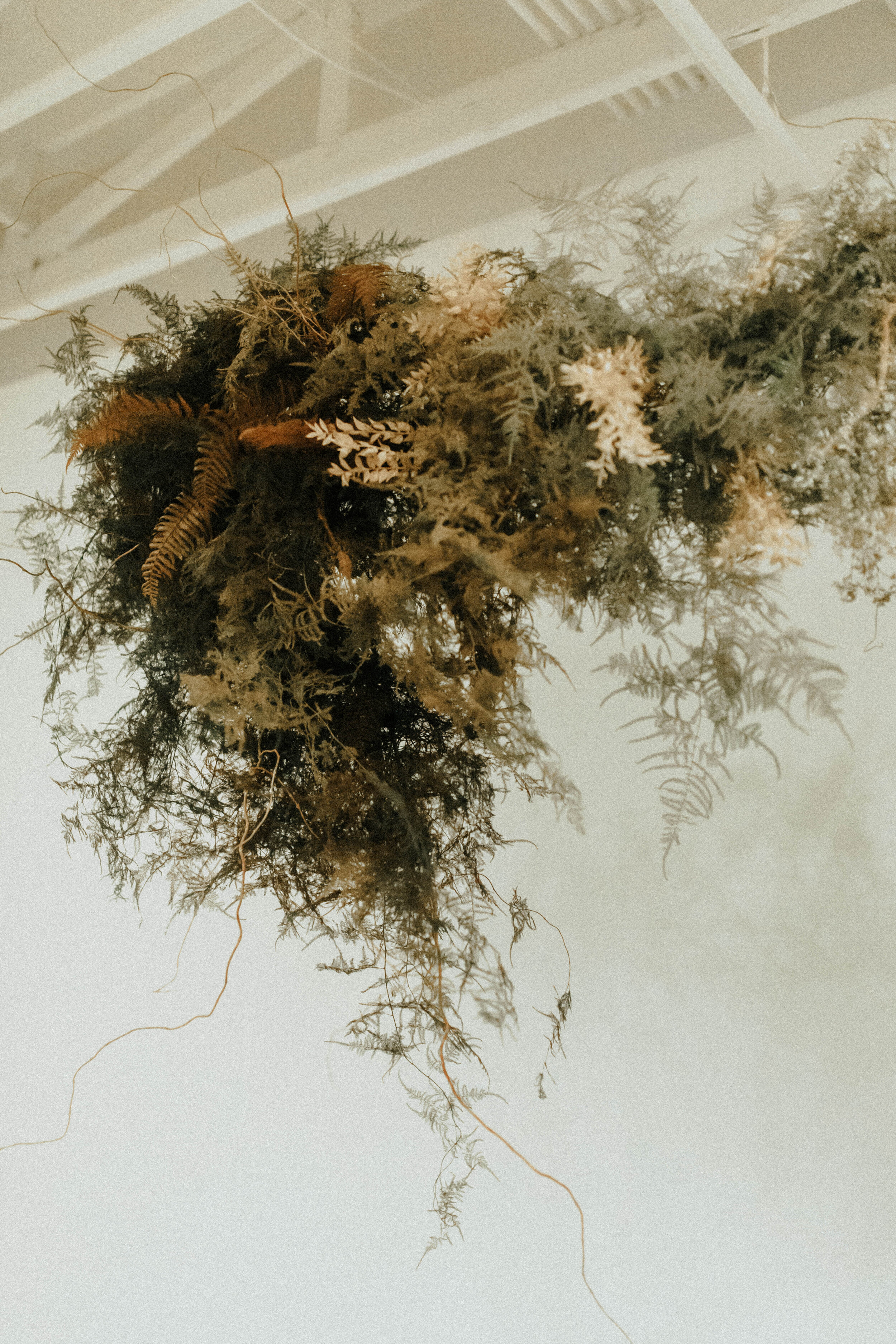 Skin tone inspired wearable floral design inspiration shoot. Earth tone hanging flower installation at the Saint Elle, Nashville.