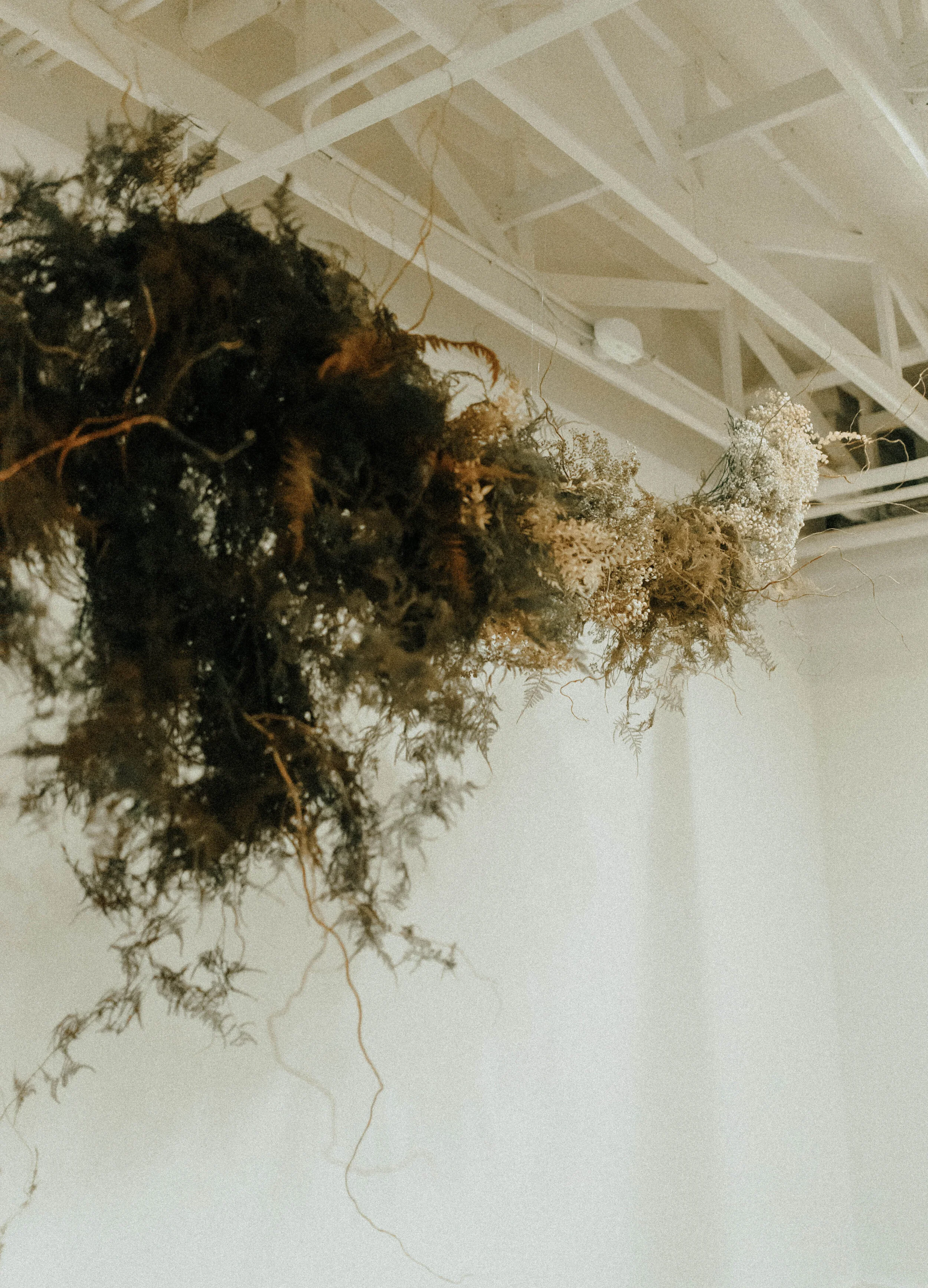 Skin tone inspired wearable floral design inspiration shoot. Earth tone hanging flower installation at the Saint Elle, Nashville.