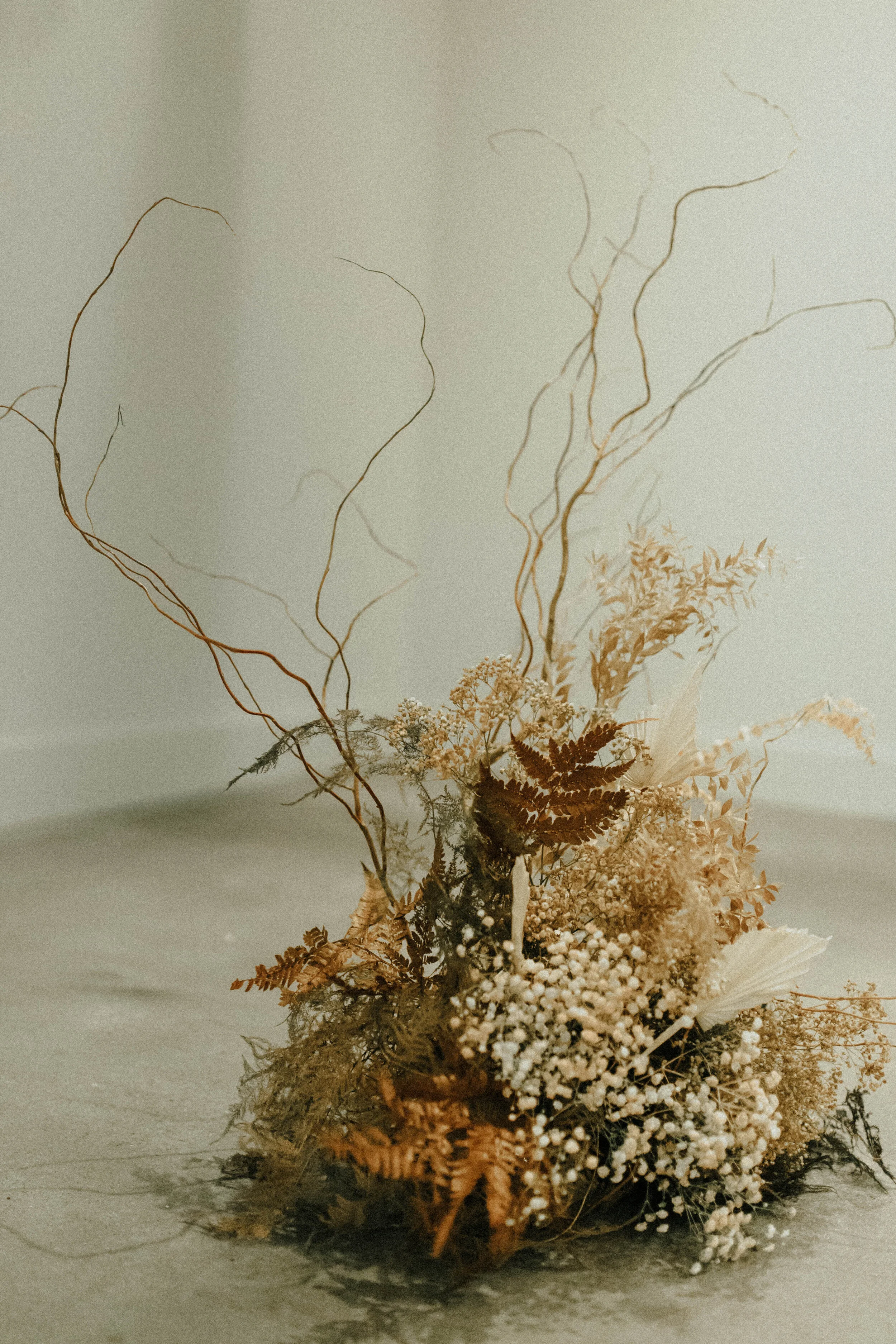Skin tone inspired wearable floral design inspiration shoot. Earth tone hanging flower installation at the Saint Elle, Nashville.