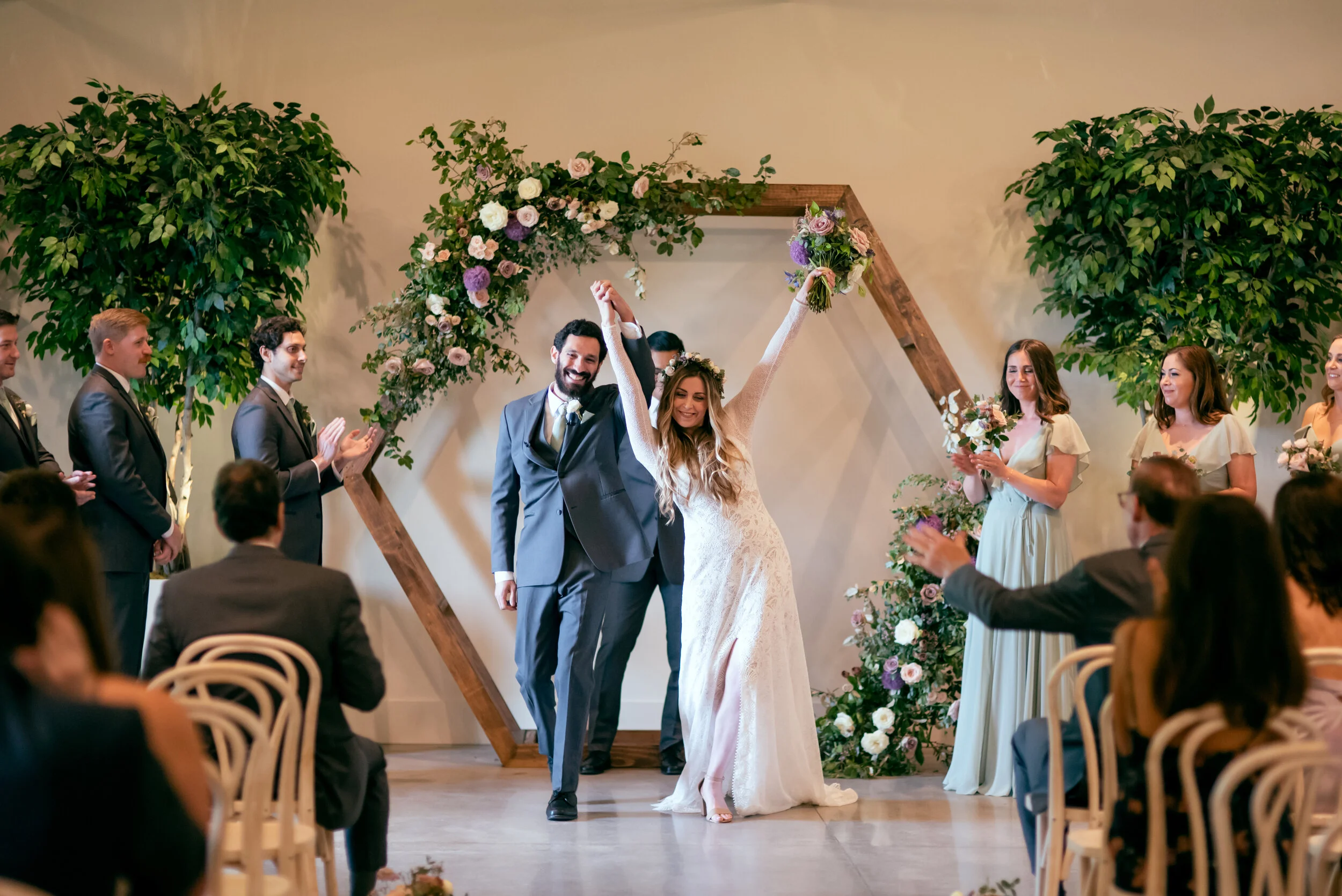 Hexagon floral arch in minimal venue with lots of plants. Lavender and mauve color palette, Nashville wedding floral design.