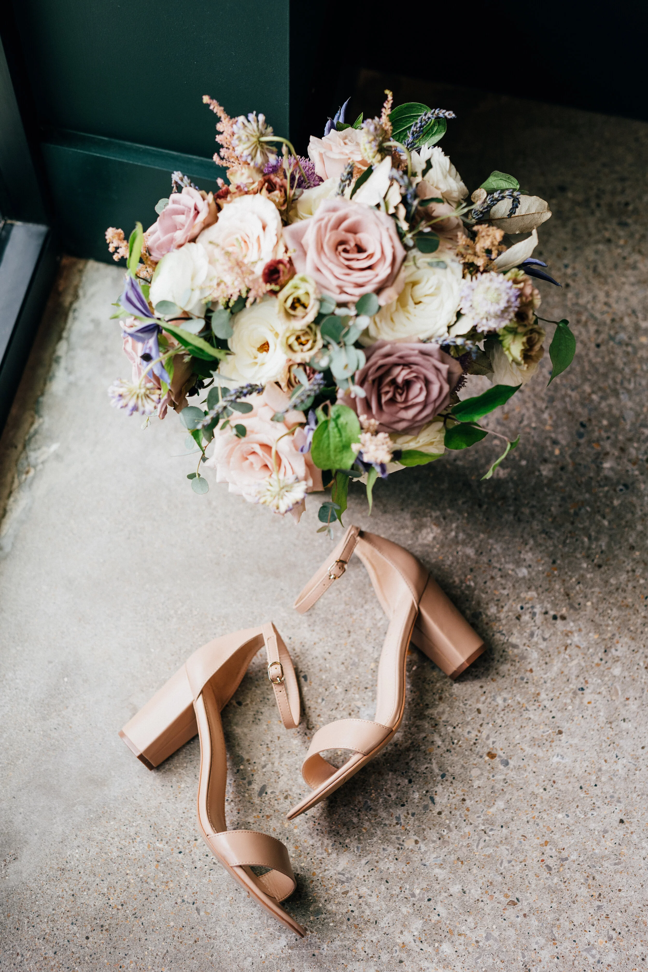 Lavender, mauve, and lilac bridal bouquet with garden roses, ranunculus, astilbe, scabies, clematis, eucalyptus, and greenery. Nashville wedding floral designer at the Saint Elle.