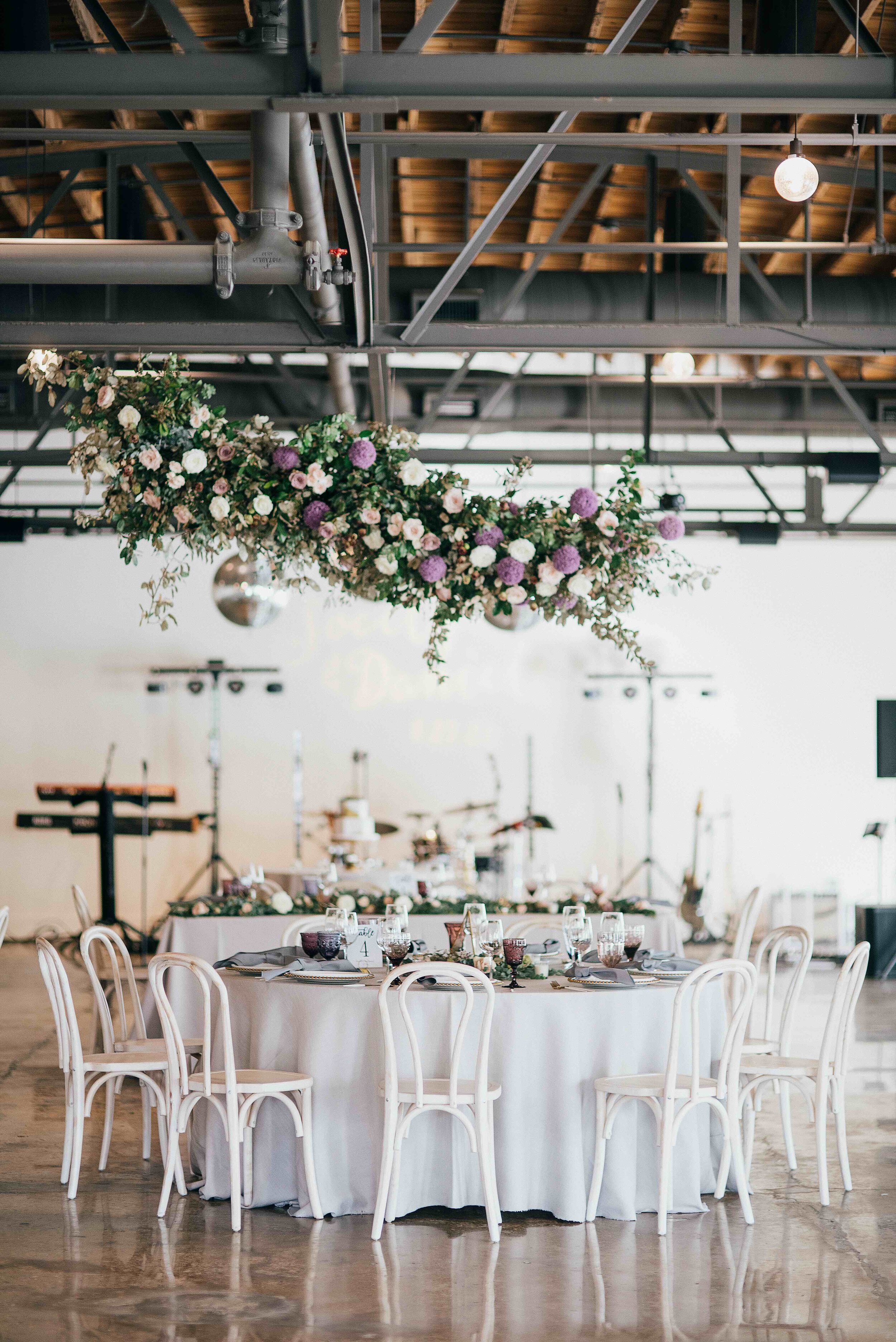 Floating floral cloud installation with mauve garden roses, purple allium, blush spray roses, and lush, untamed greenery. Nashville wedding florist at the Saint Elle.
