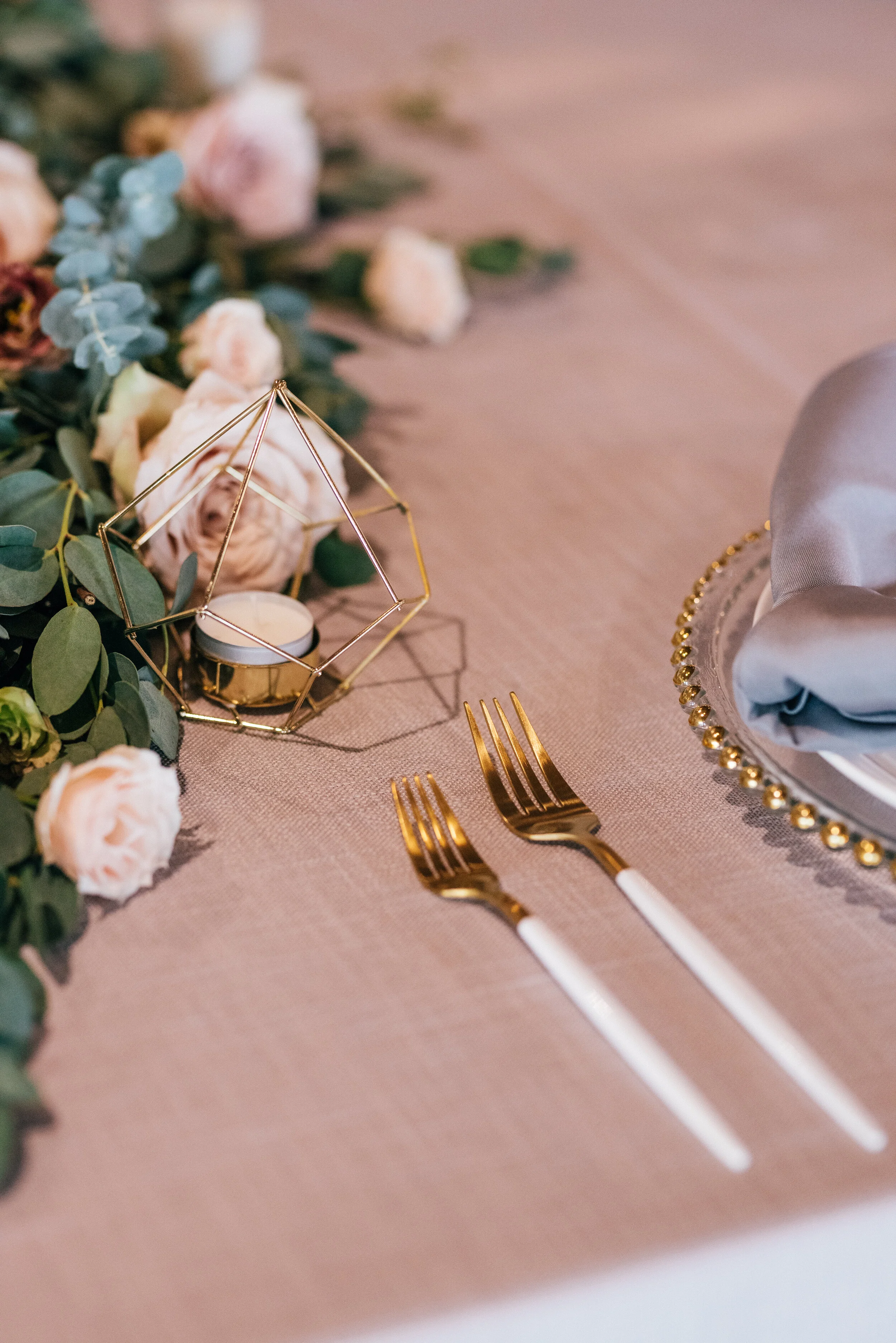 Head table garland runner of eucalyptus with blush and mauve floral accents. Nashville wedding florist.