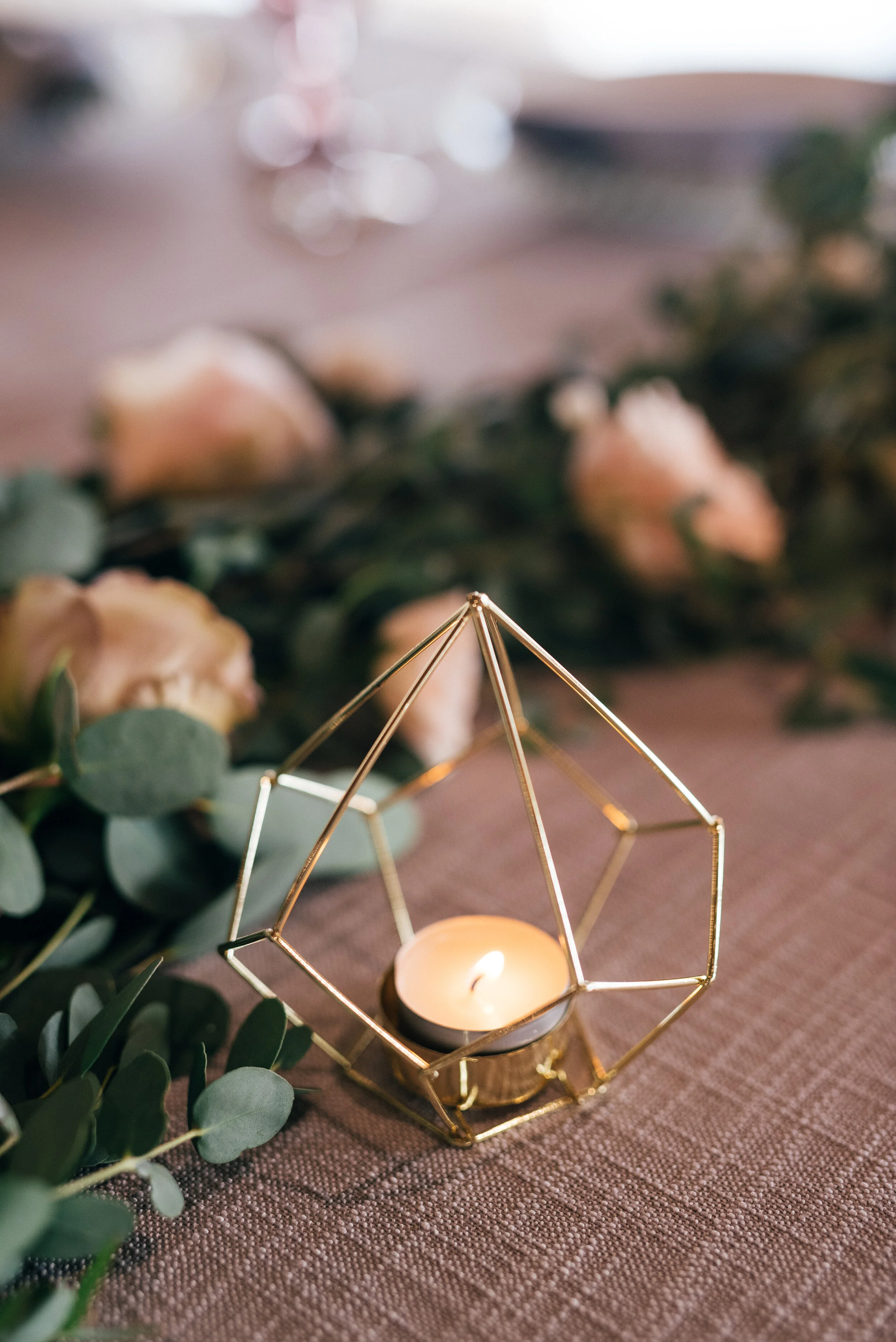 Head table garland runner of eucalyptus with blush and mauve floral accents. Nashville wedding florist.