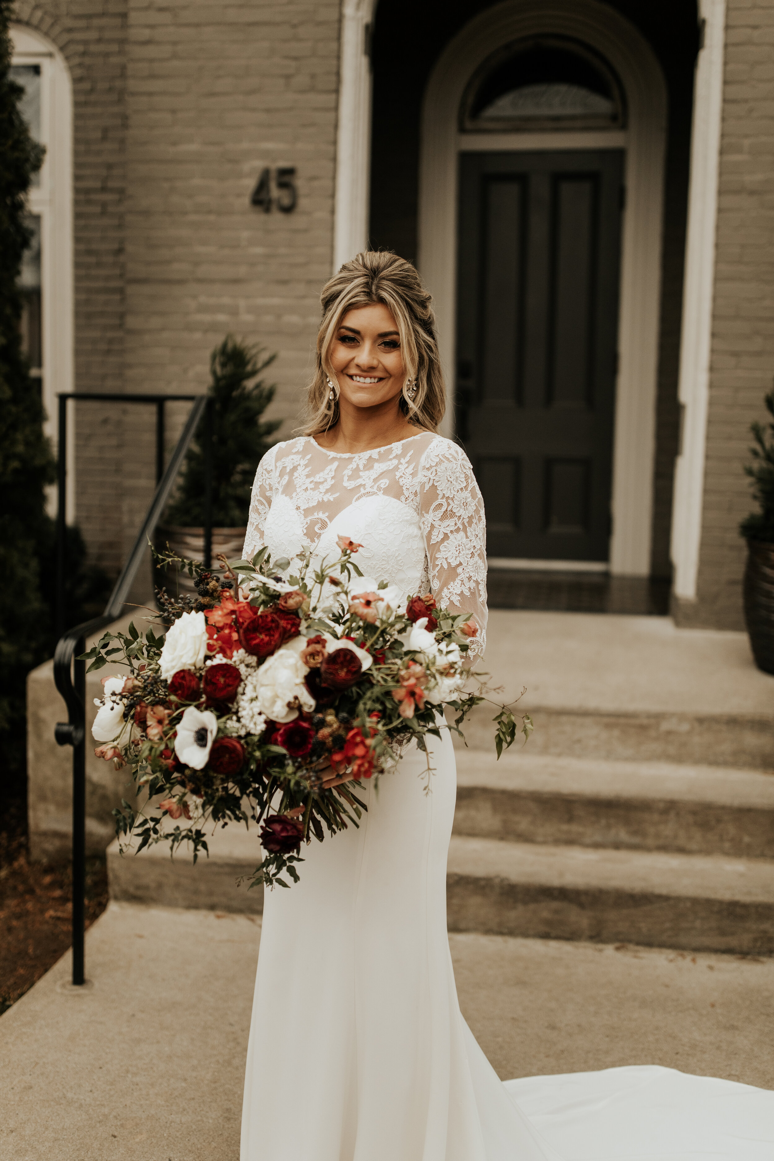Lush, wintry bridal bouquet with anemones, white and burgundy peonies, ranunculus, garden roses, jasmine vine, and natural greenery. Nashville wedding floral designer, Rosemary & Finch.