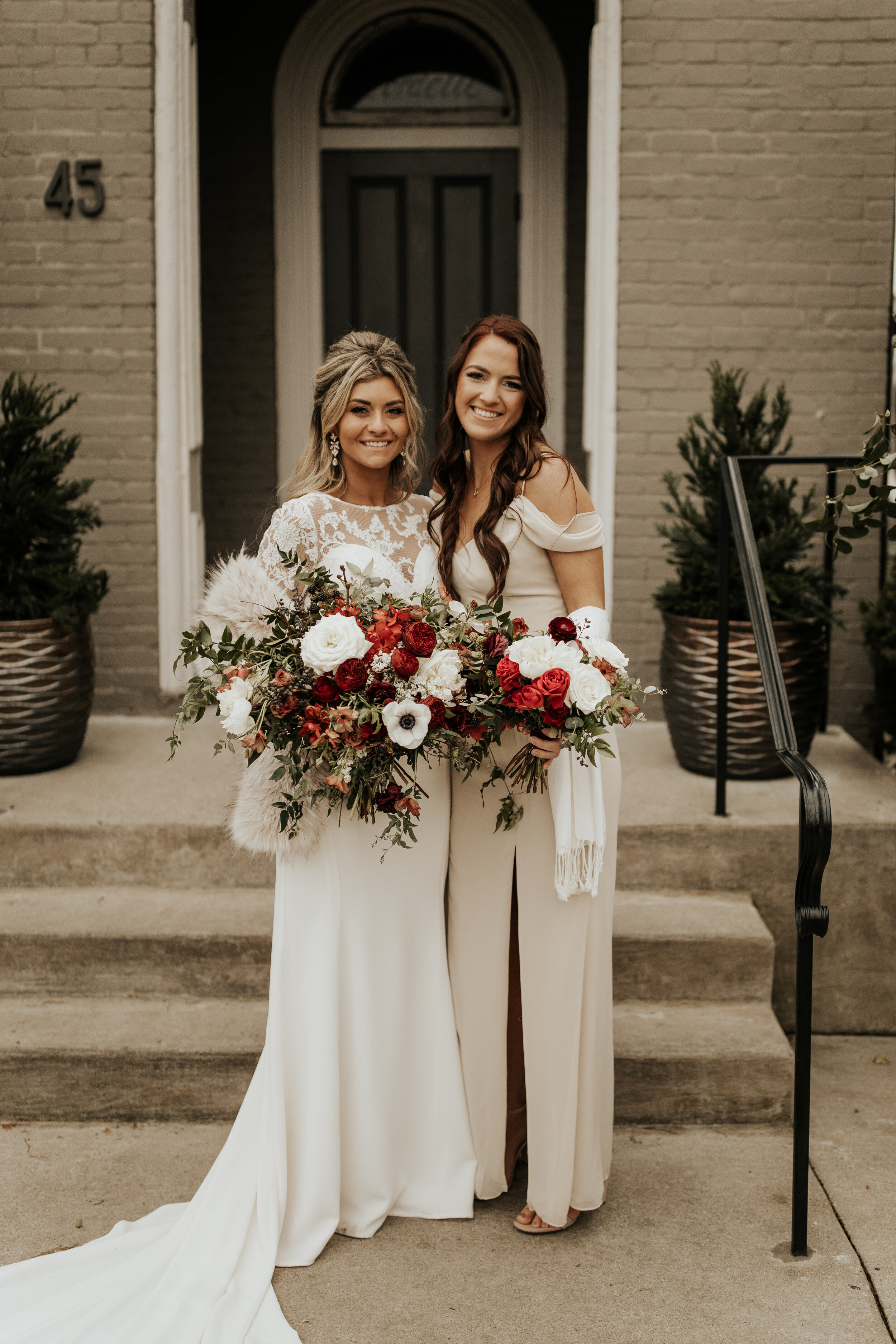 Neutral bridesmaid dresses with burgundy, white, and greenery bouquets of garden roses, peonies, and ranunculus for a wintry wedding at the Cordelle in Nashville.