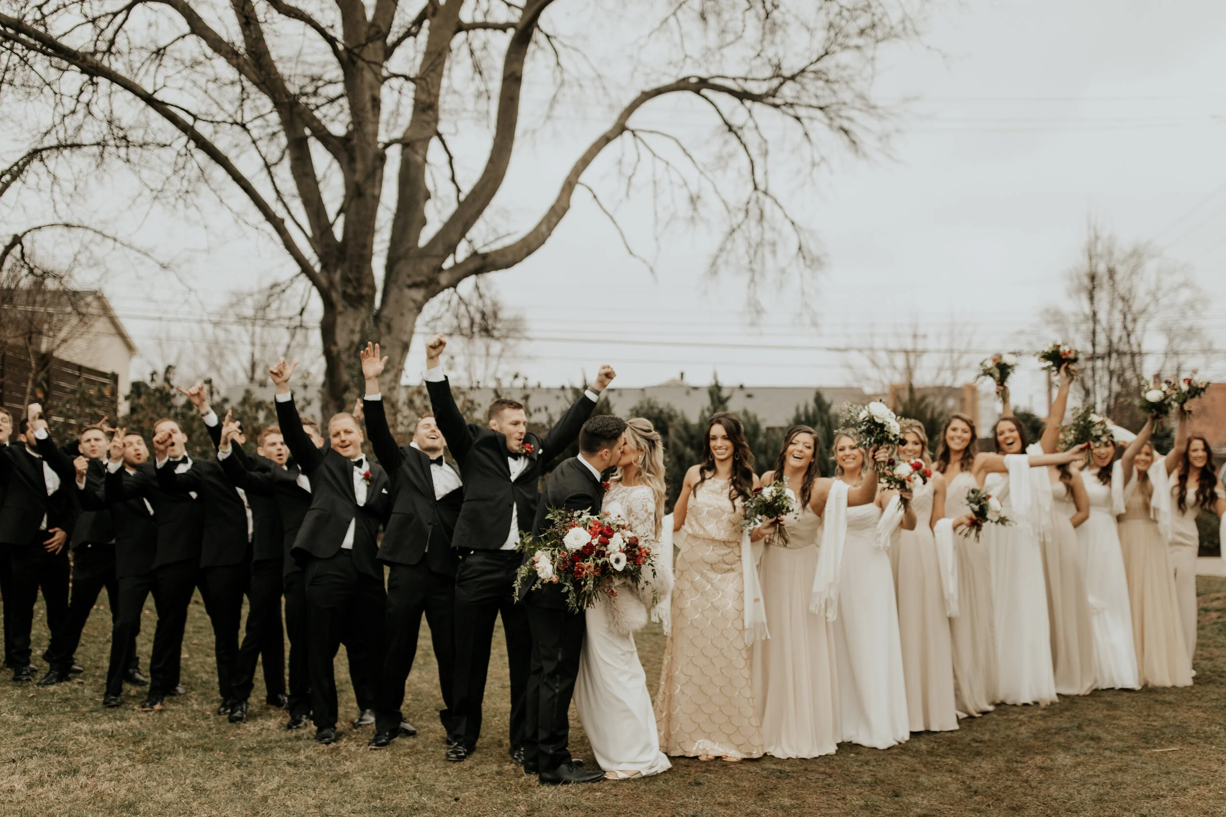 Neutral bridesmaid dresses with burgundy, white, and greenery bouquets of garden roses, peonies, and ranunculus for a wintry wedding at the Cordelle in Nashville.