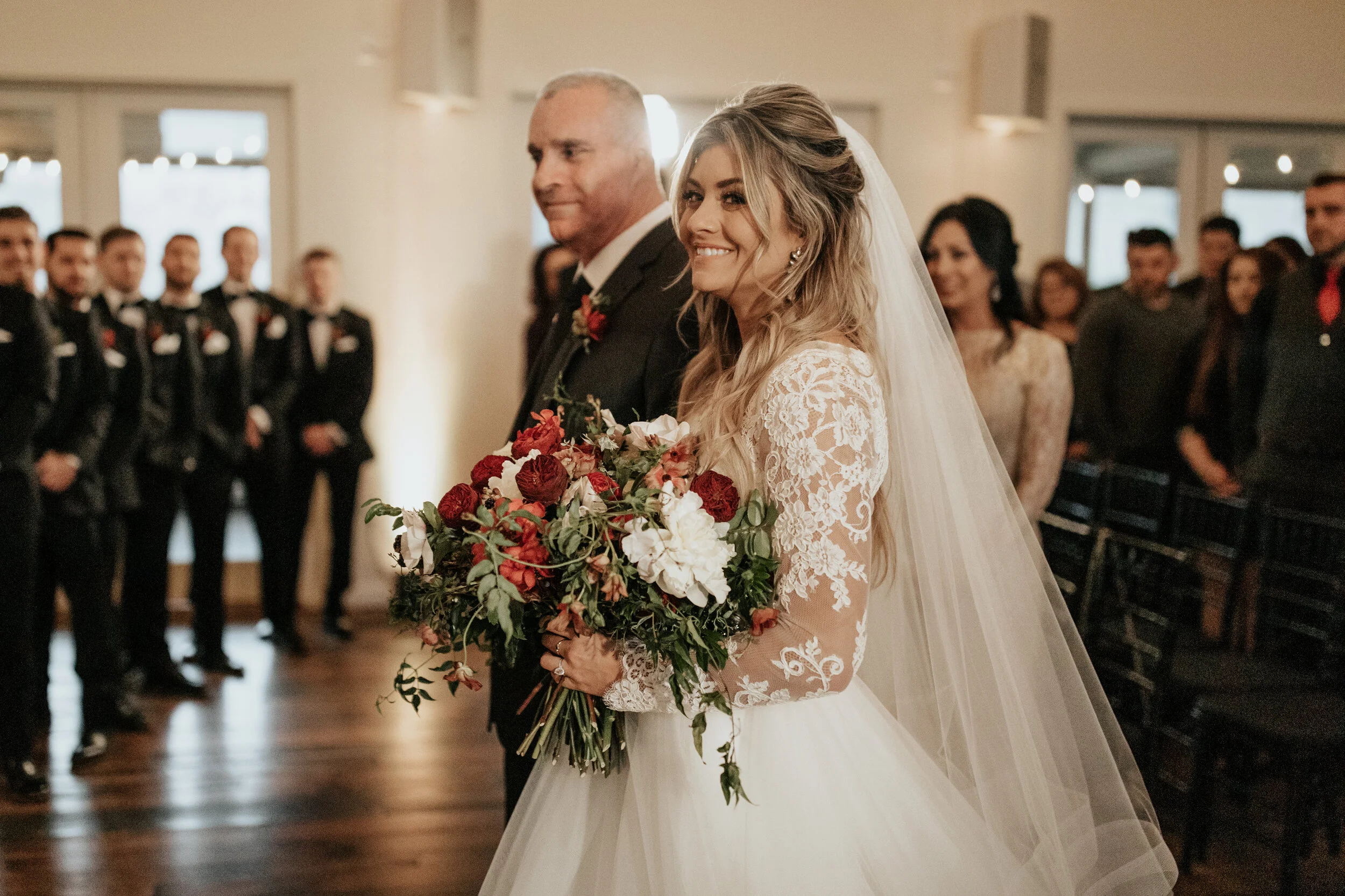 Lush, wintry bridal bouquet with anemones, white and burgundy peonies, ranunculus, garden roses, jasmine vine, and natural greenery. Nashville wedding floral designer, Rosemary & Finch.