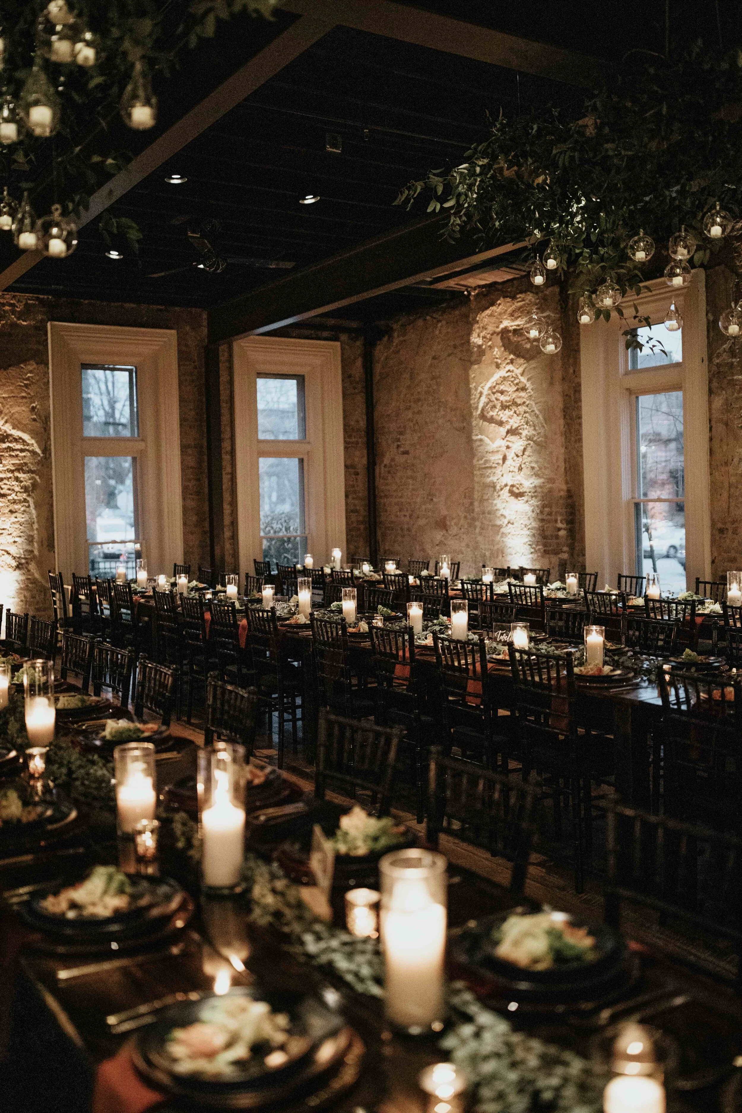 Hanging terrarium candle installation with lush greenery. Nashville wedding floral design at the Cordelle.