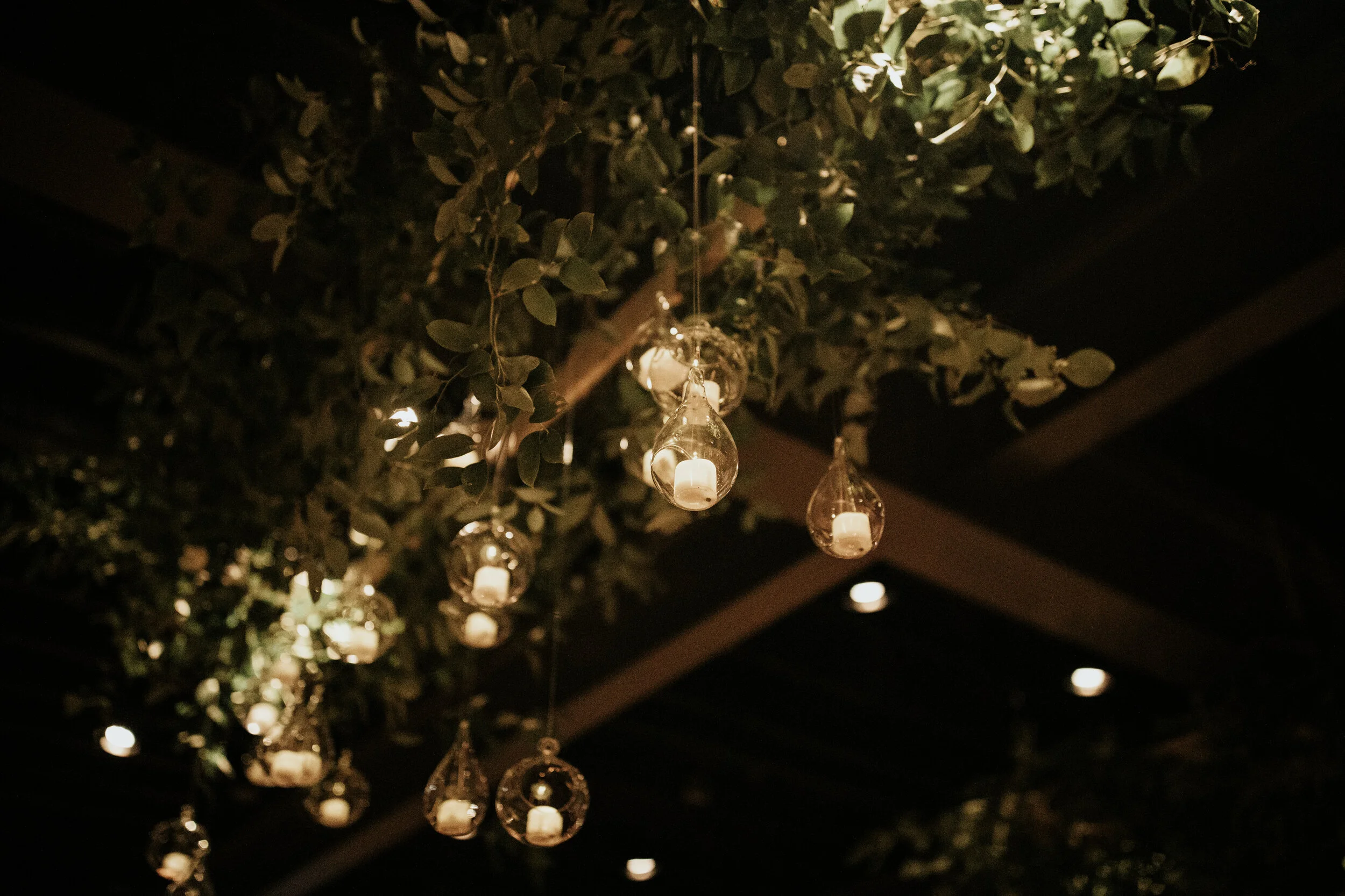 Hanging terrarium candle installation with lush greenery. Nashville wedding floral design at the Cordelle.