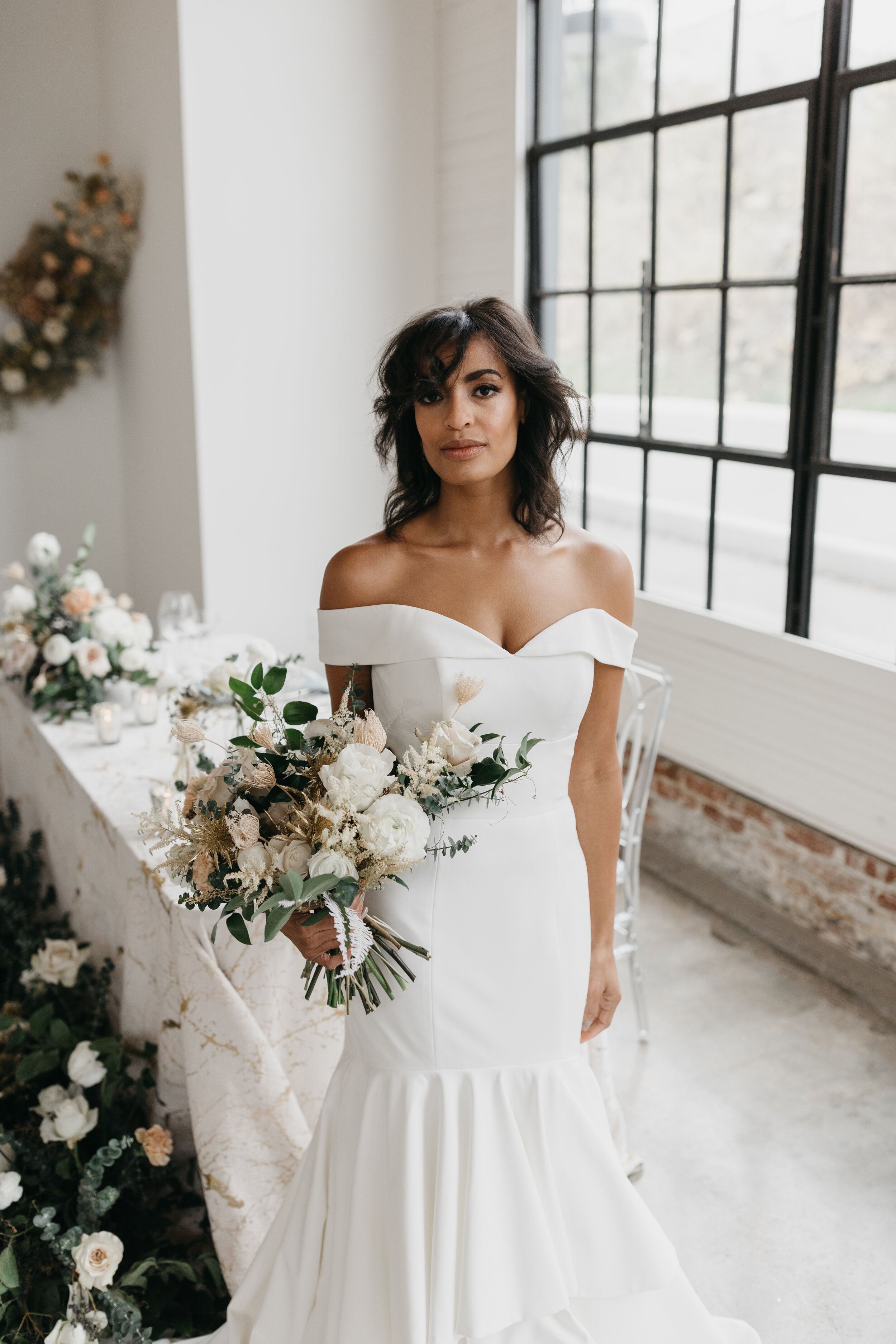 Wintery bouquet filled with fresh and dried florals, white roses, quicksand roses, astilbe, baby eucalyptus, lush greenery, and touches of gold. Nashville wedding florist Rosemary & Finch at OZARI.
