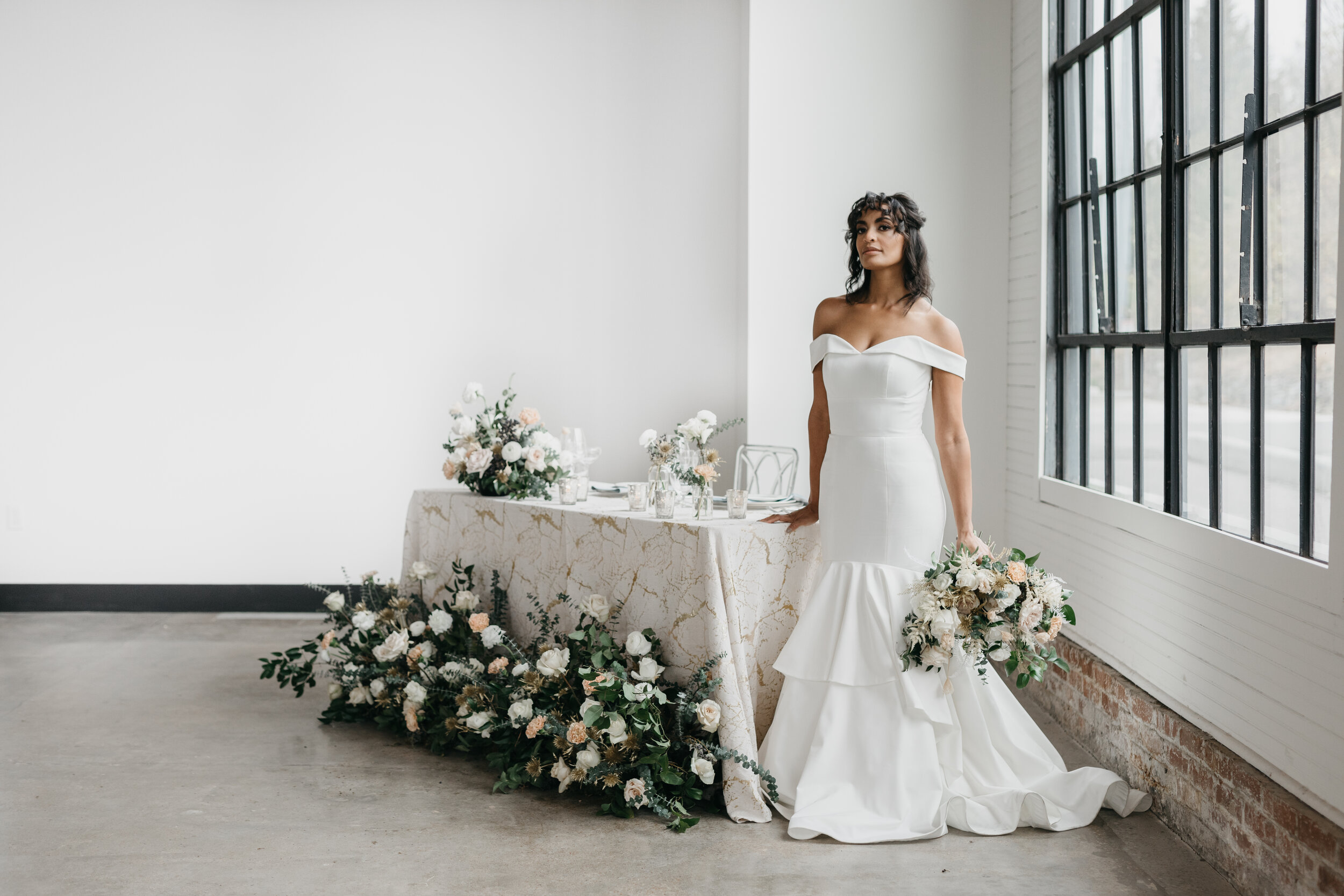 Wintery growing floor installation and tablescape featuring white and quicksand roses, touches of gold, baby eucalyptus and lush greenery. Nashville wedding florist Rosemary & Finch at OZARI.