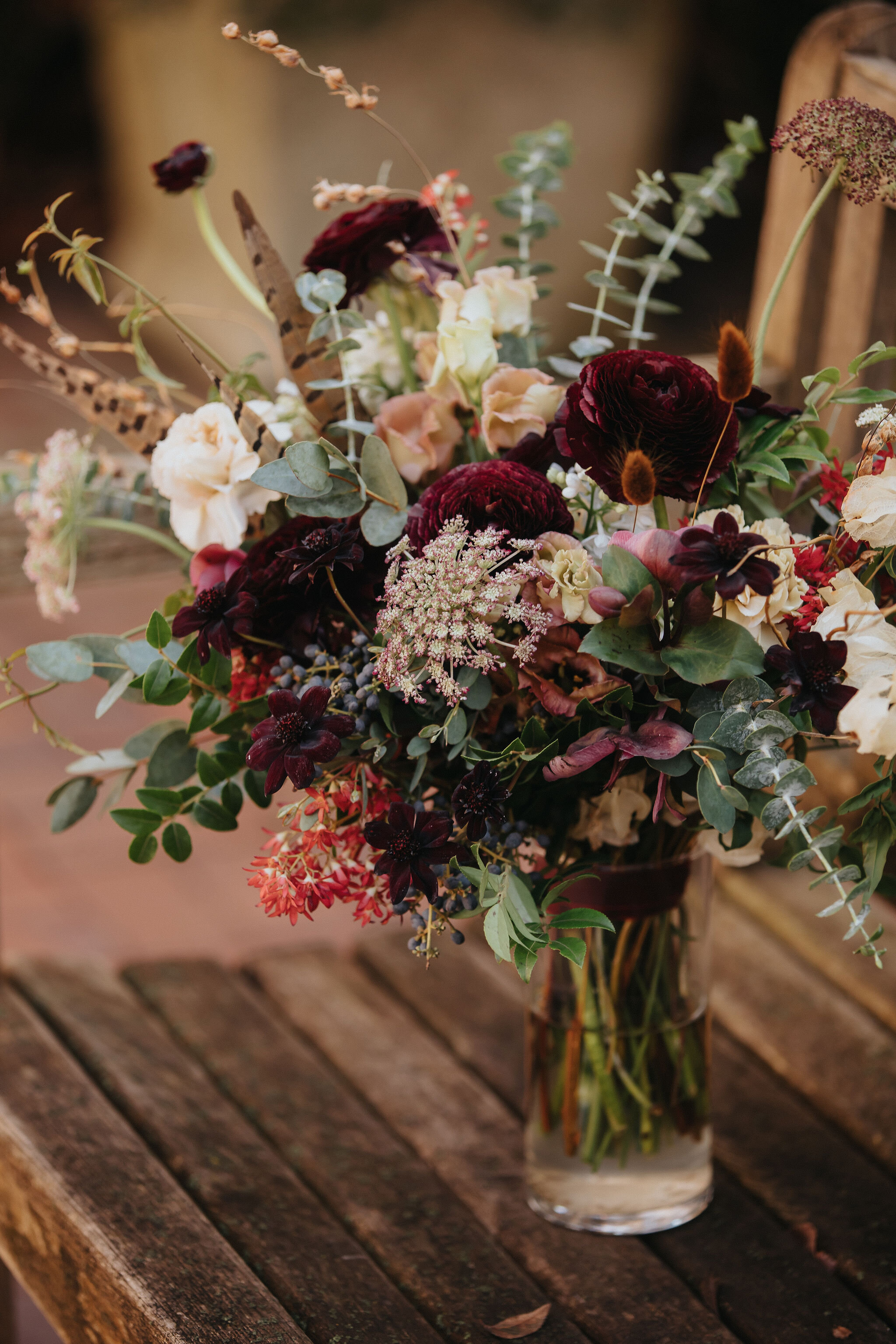 A perfect botanical and moody bouquet filled with Chocolate Cosmos, Queen Ann's Lace, Baby Eucalyptus, Rust Bunny Tails, Festival Bush, Antique Carnations, Burgundy Ranunculus, and Brown Lisianthus. Designed by Nashville wedding floral designer, Ros…