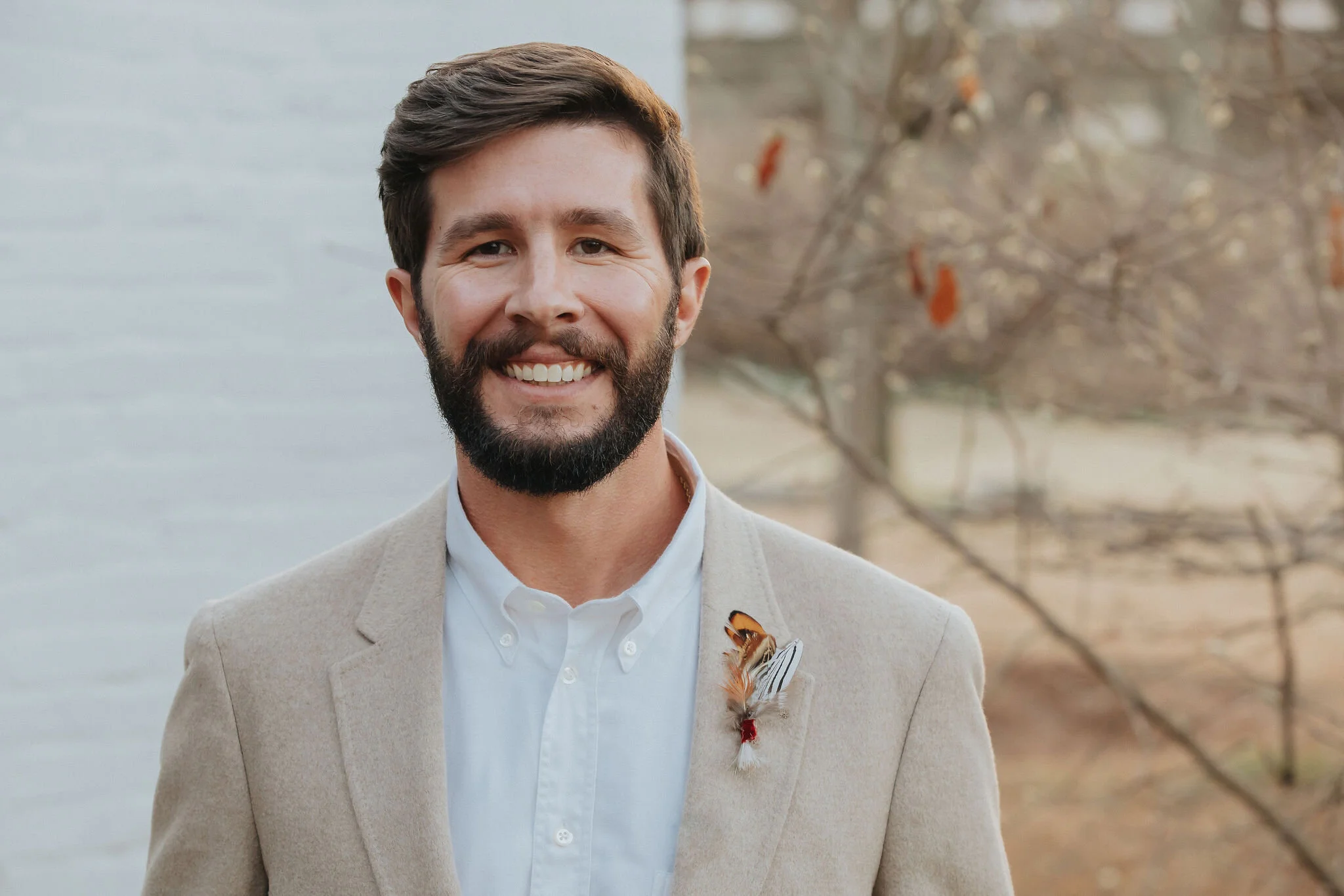 Delicate boutonnière of pheasant feathers. Designed by Nashville wedding floral designer, Rosemary & Finch at Long Hollow Gardens.