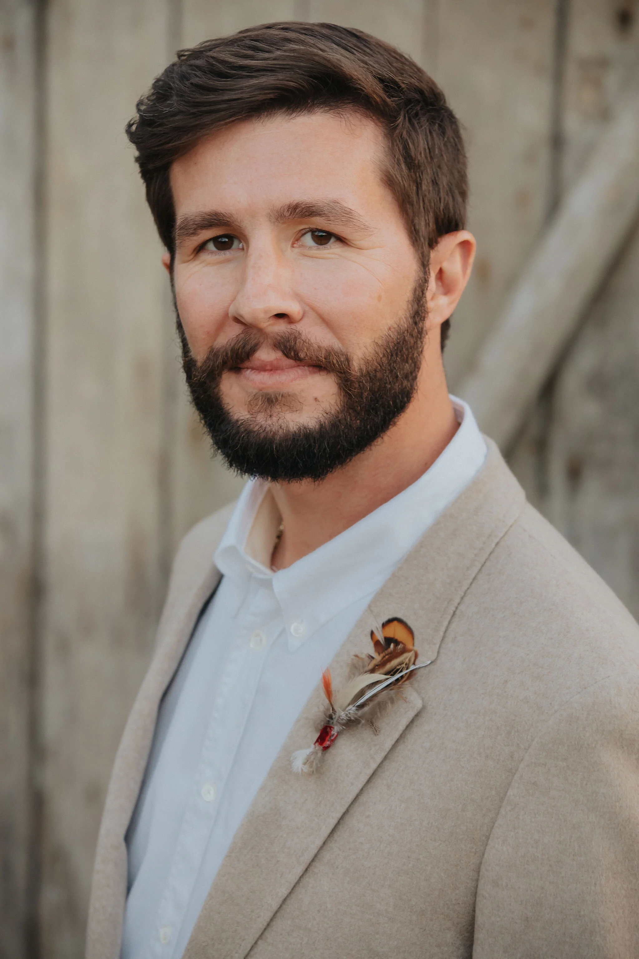 Delicate boutonnière of pheasant feathers. Designed by Nashville wedding floral designer, Rosemary & Finch at Long Hollow Gardens.