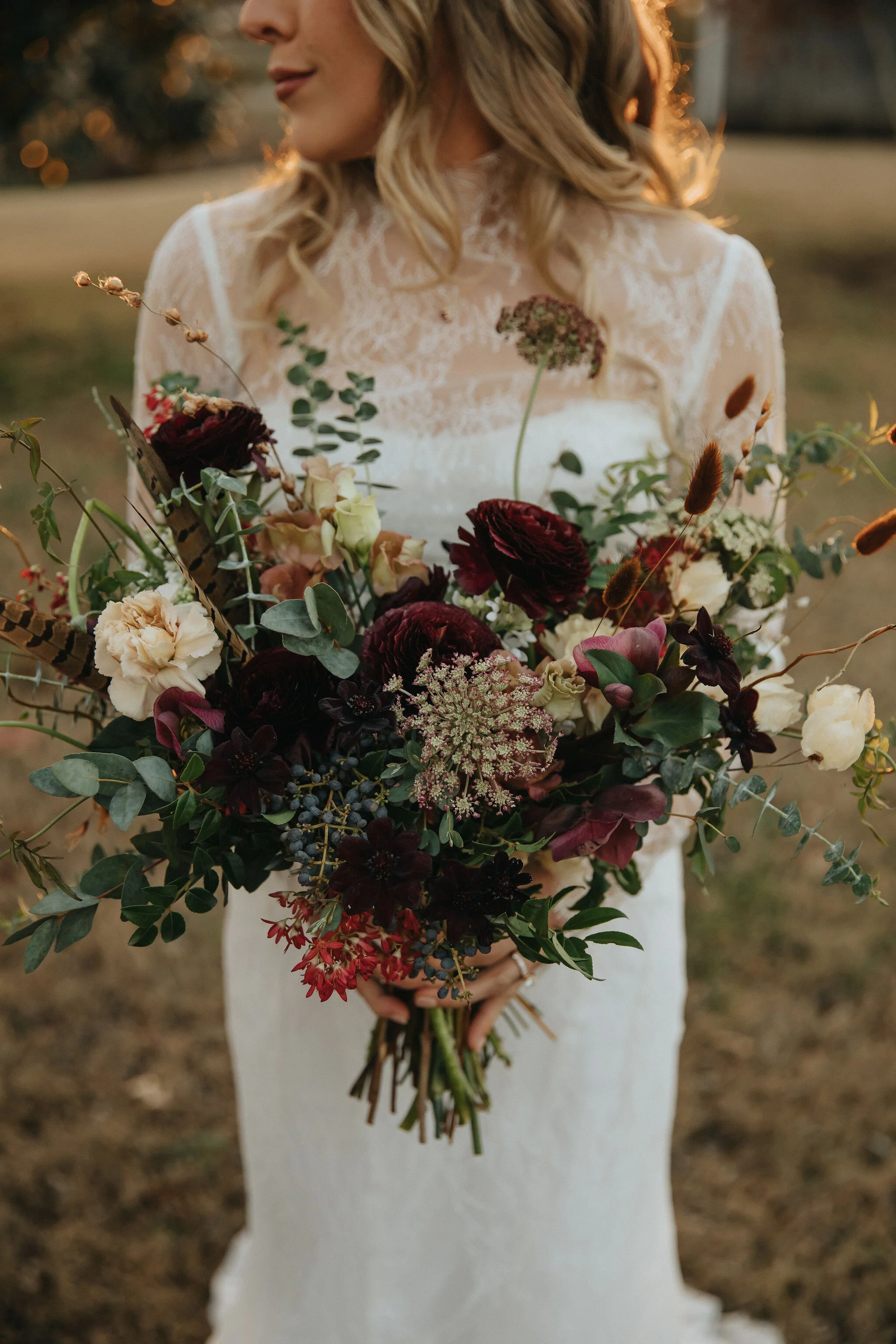 A perfect botanical and moody Bridal bouquet filled with Chocolate Cosmos, Queen Ann's Lace, Baby Eucalyptus, Rust Bunny Tails, Festival Bush, Antique Carnations, Burgundy Ranunculus, and Brown Lisianthus. Designed by Nashville wedding floral design…