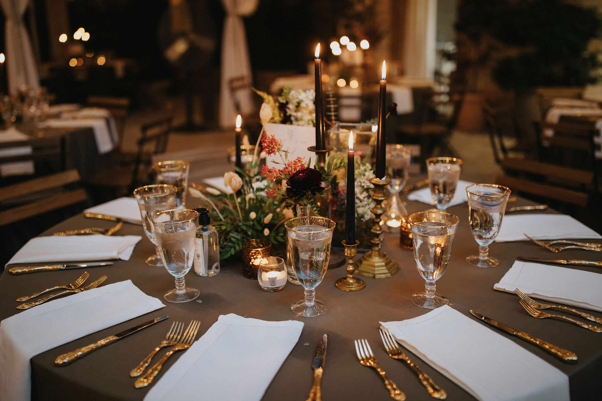 Earthy and romantic – this eclectic tablescape is crafted from pheasant feathers, brass candlesticks, and layered florals. Botanical cloches are filled with fern, moss, chocolate cosmos, and ranunculus. Designed by Nashville wedding floral designer,…