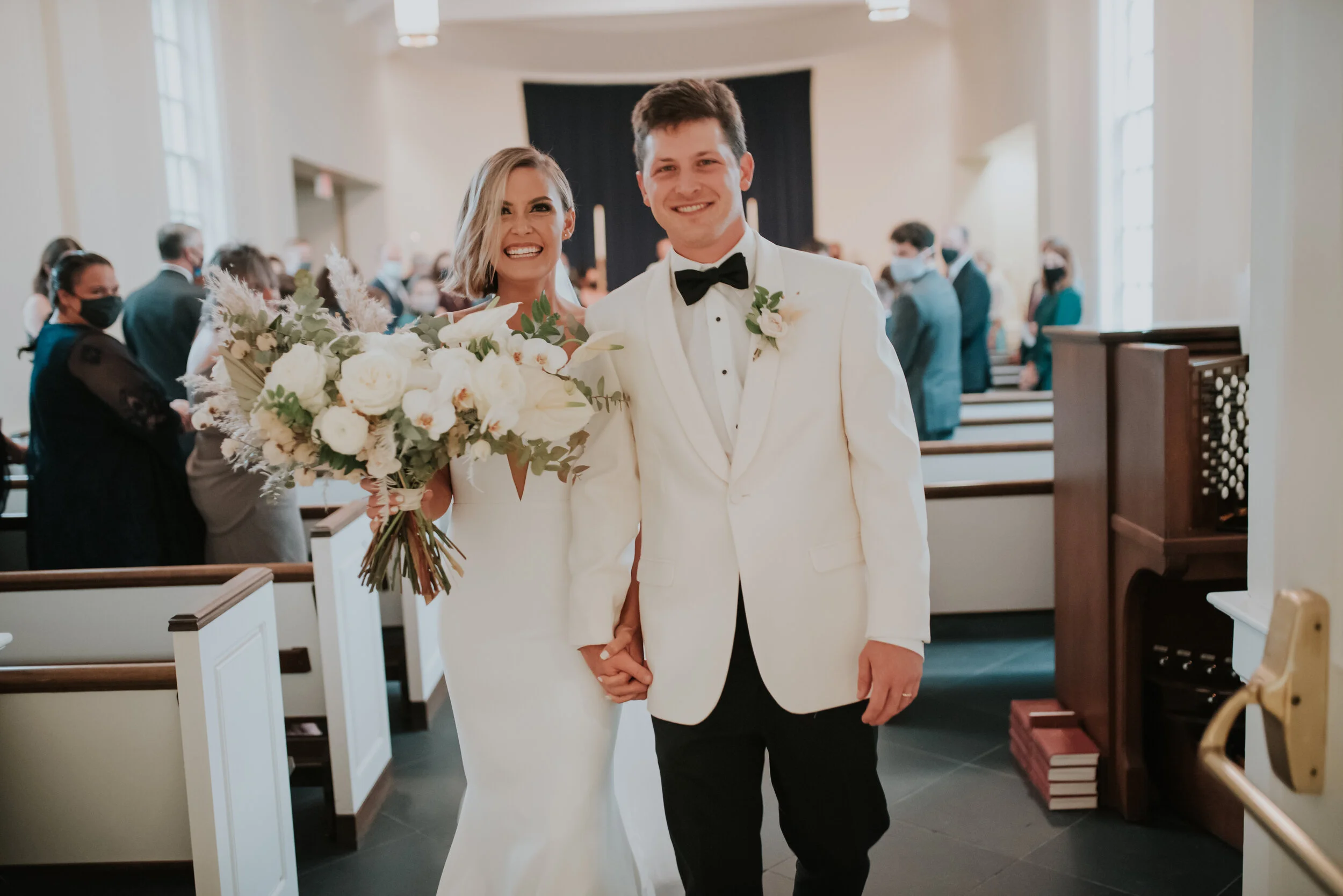 Bohemian and modern yet classically elegant. This Bridal bouquet perfectly married boho elements of pampas grass, eucalyptus, and dried florals with topical stems of anthurium, orchid and ranunculus for a fresh take on white. Designed by Nashville w…